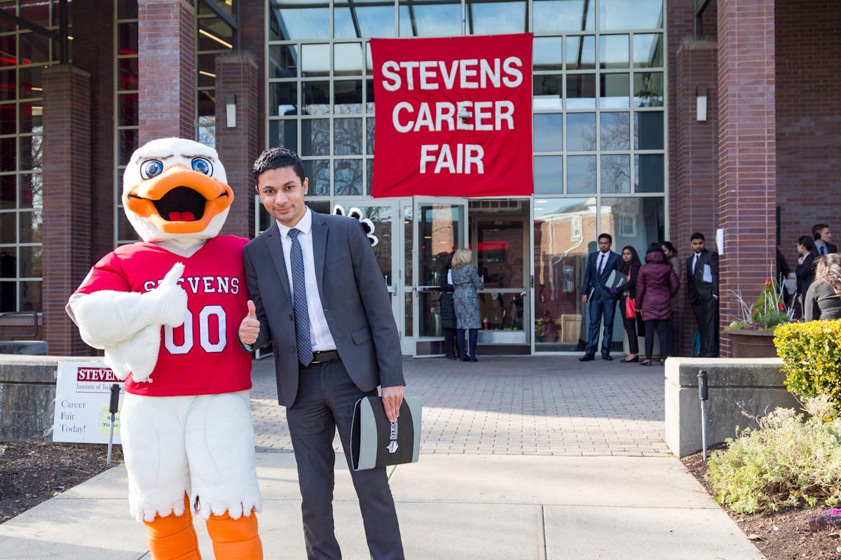 Attila with male student at Career Fair 