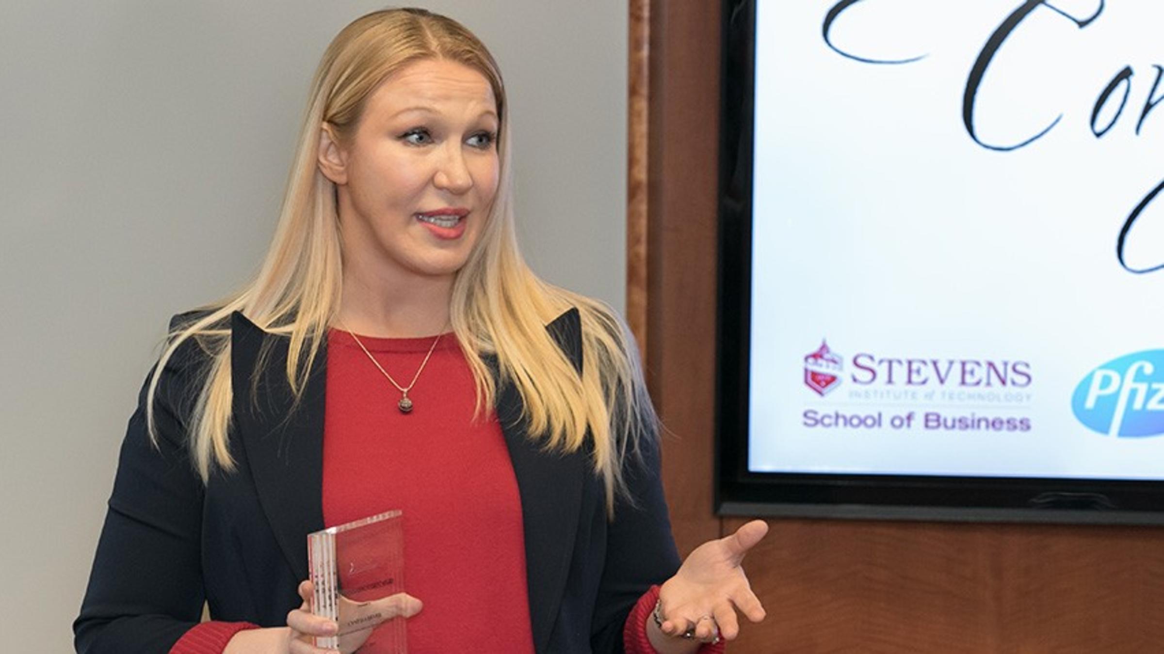 Cindy Dever accepts an award at a podium.