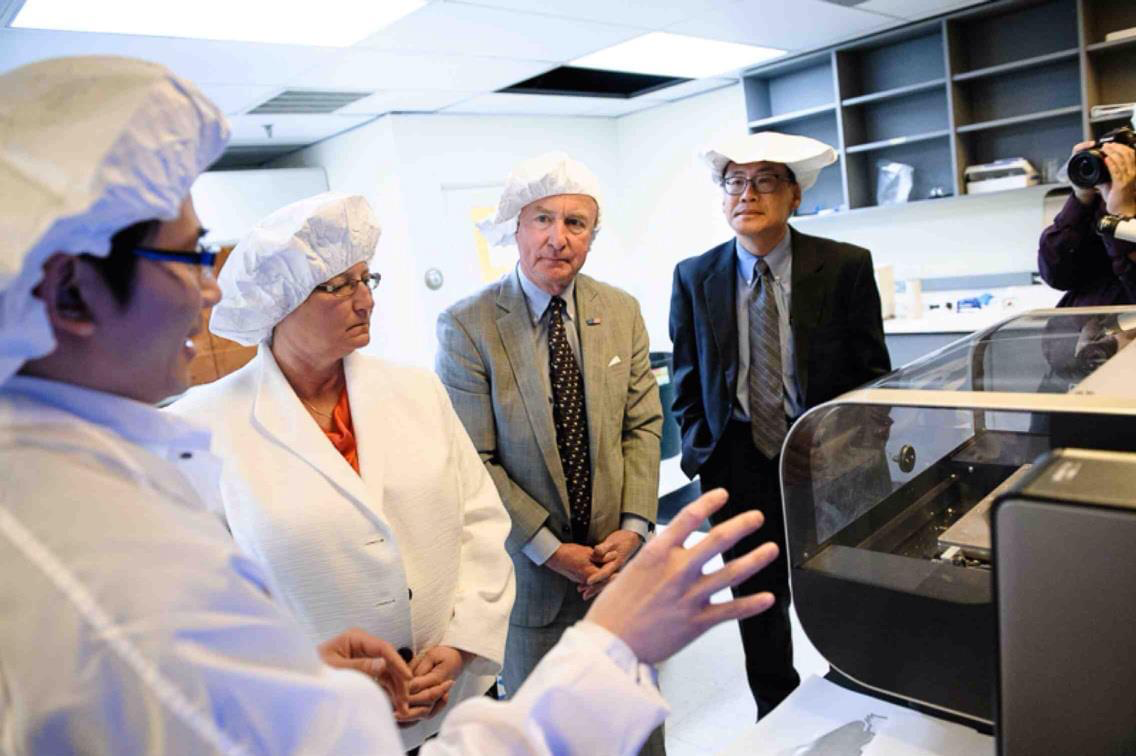 Linh, Woo, and colleagues in the lab