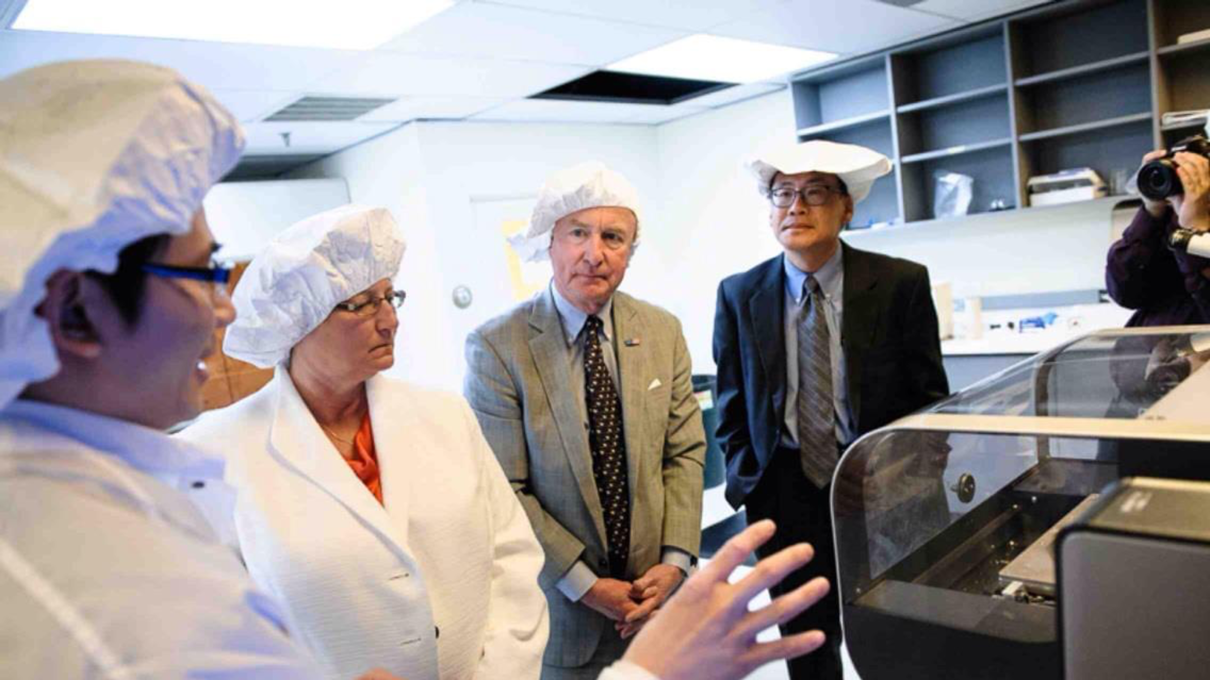 Linh, Woo, and colleagues in the lab