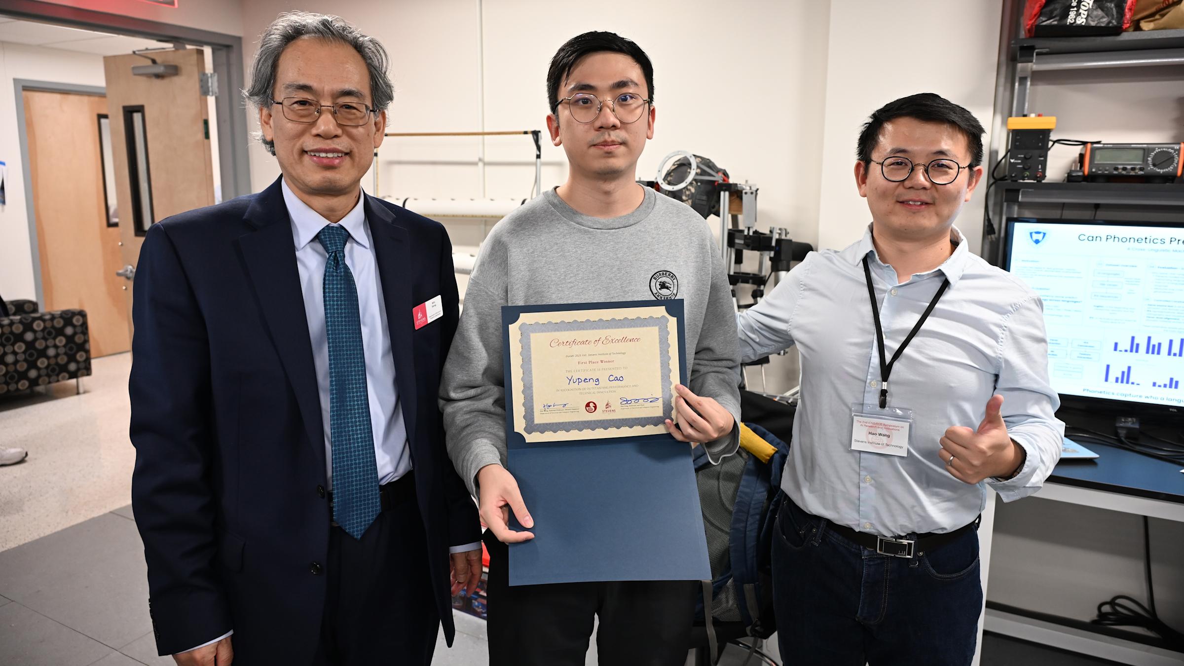 iCNS AI Engineering and Science Symposium first place winner Yupeng Cao (center), pictured with Min Song (at left) and Hao Wang.