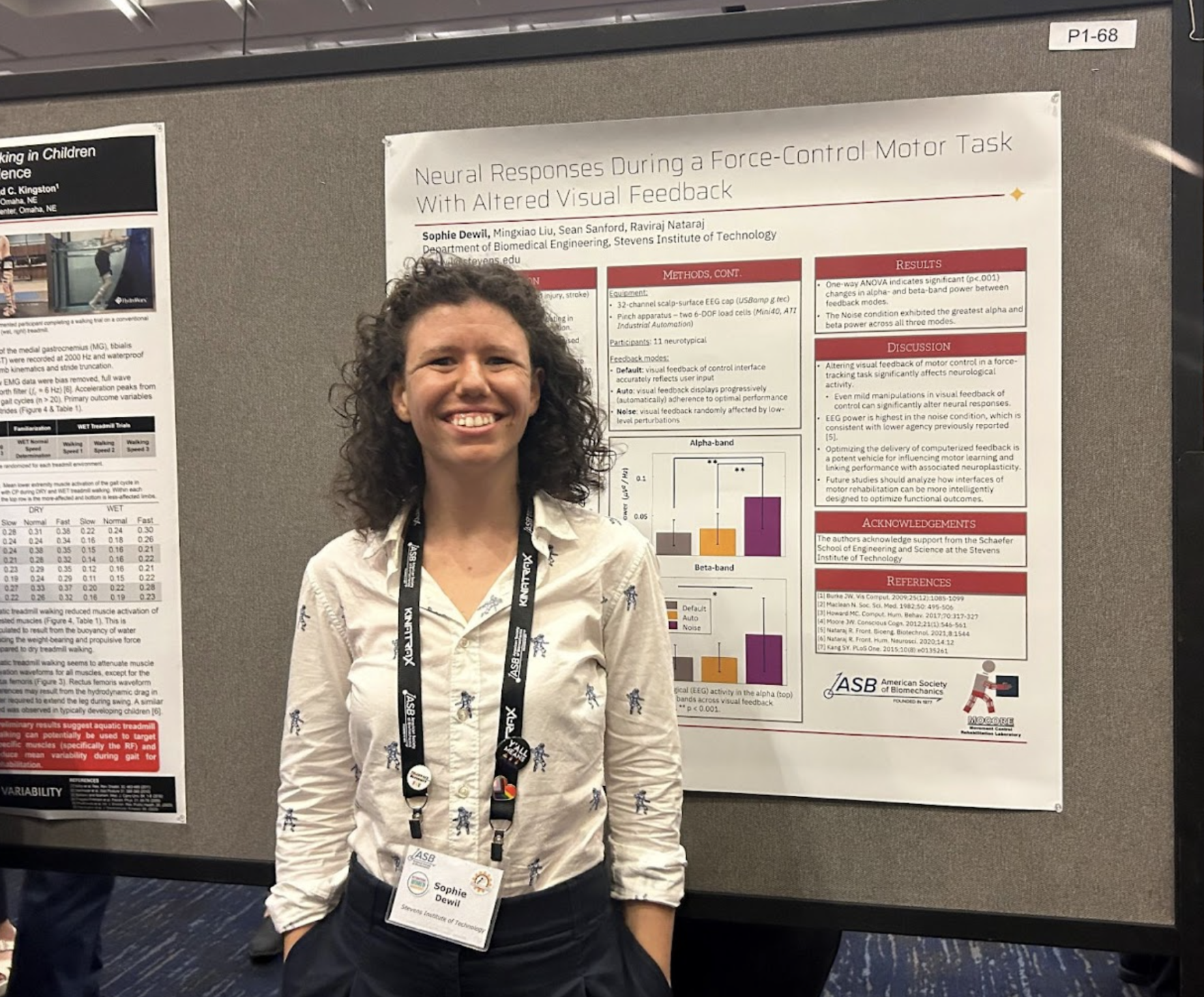 Photo of Ph.D. student Dewil standing in front of her poster presentation.