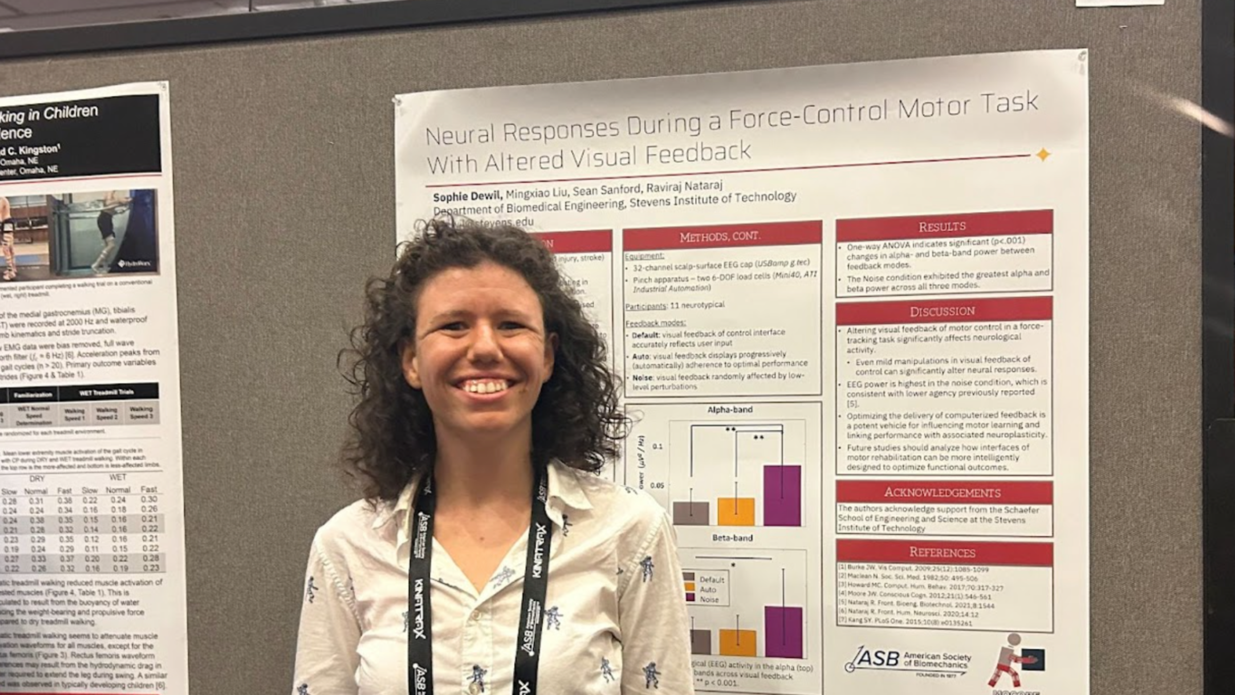 Photo of Ph.D. student Dewil standing in front of her poster presentation.