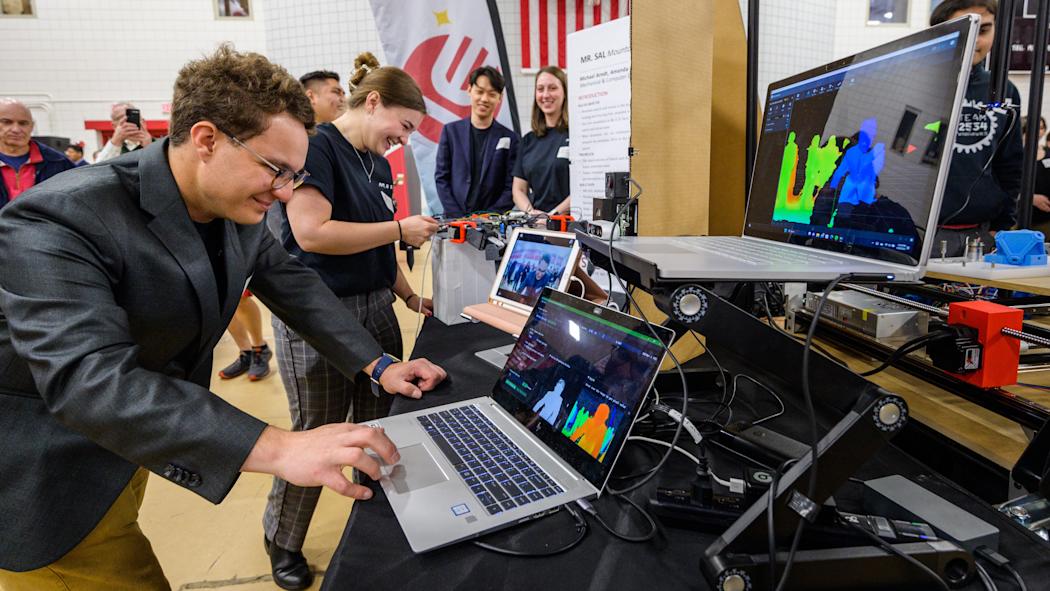 Stevens students interact upon laptop computers during Innovation Expo.