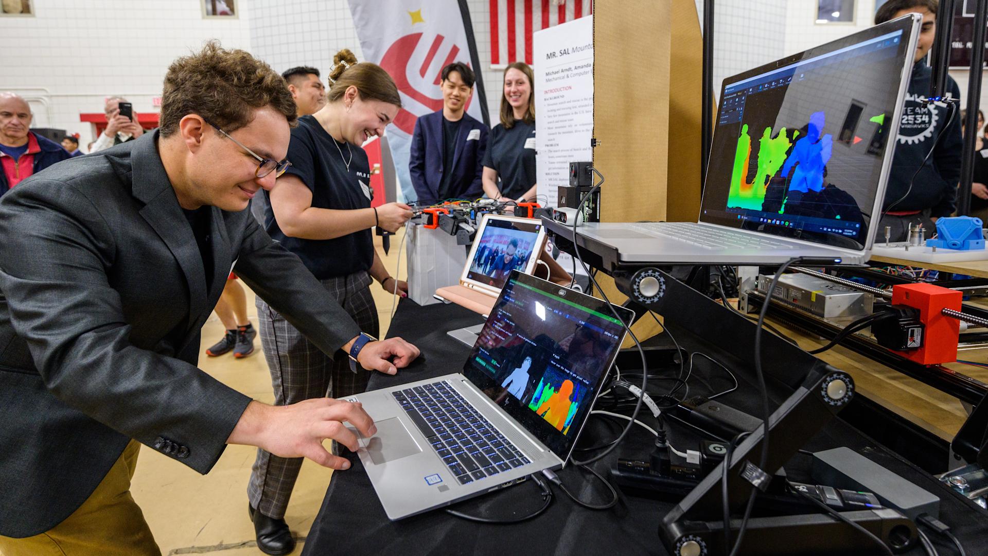 Stevens students interact upon laptop computers during Innovation Expo.