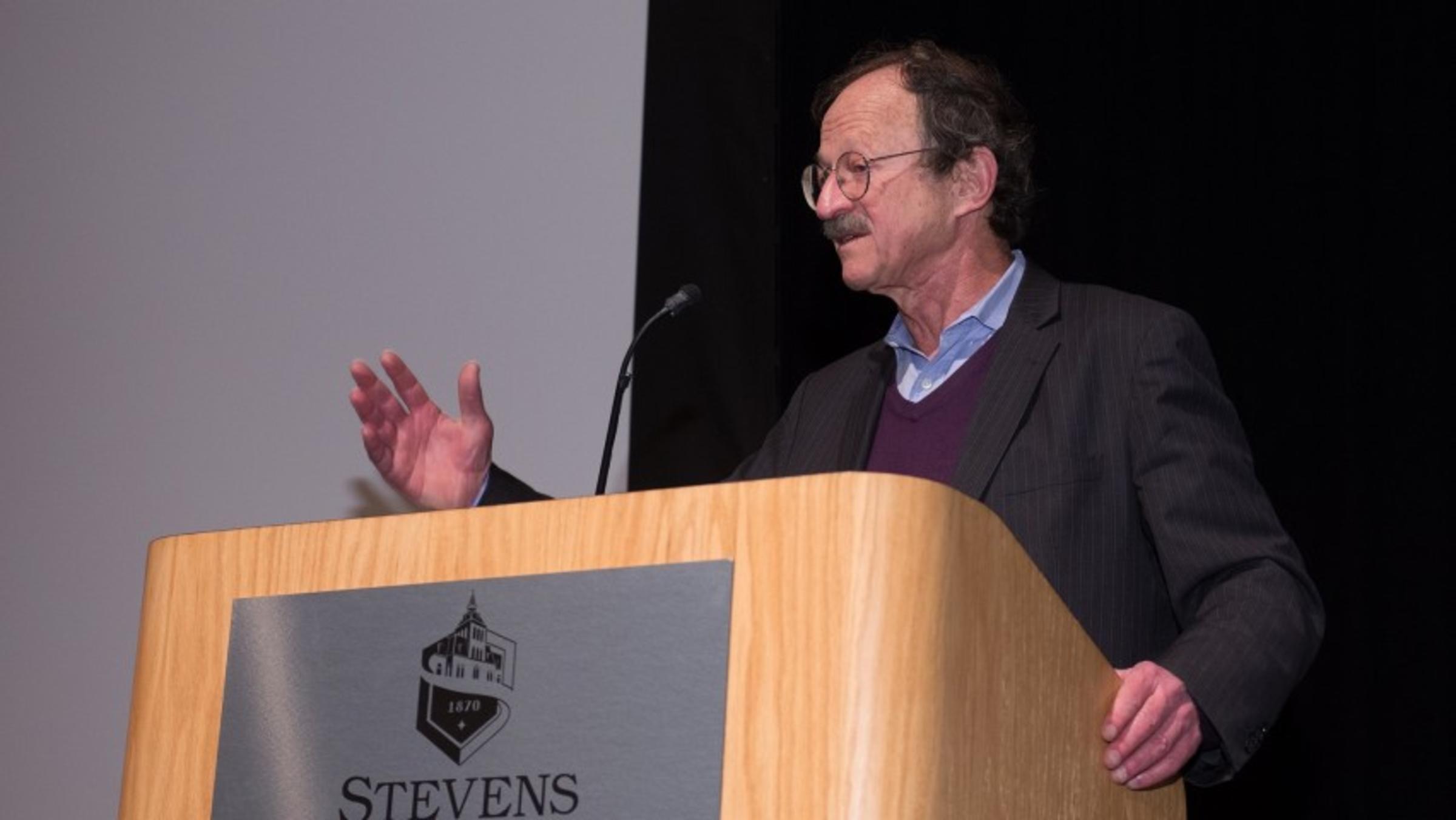 Dr. Harold Varmus giving a speech at a podium at Stevens Institute of Technology