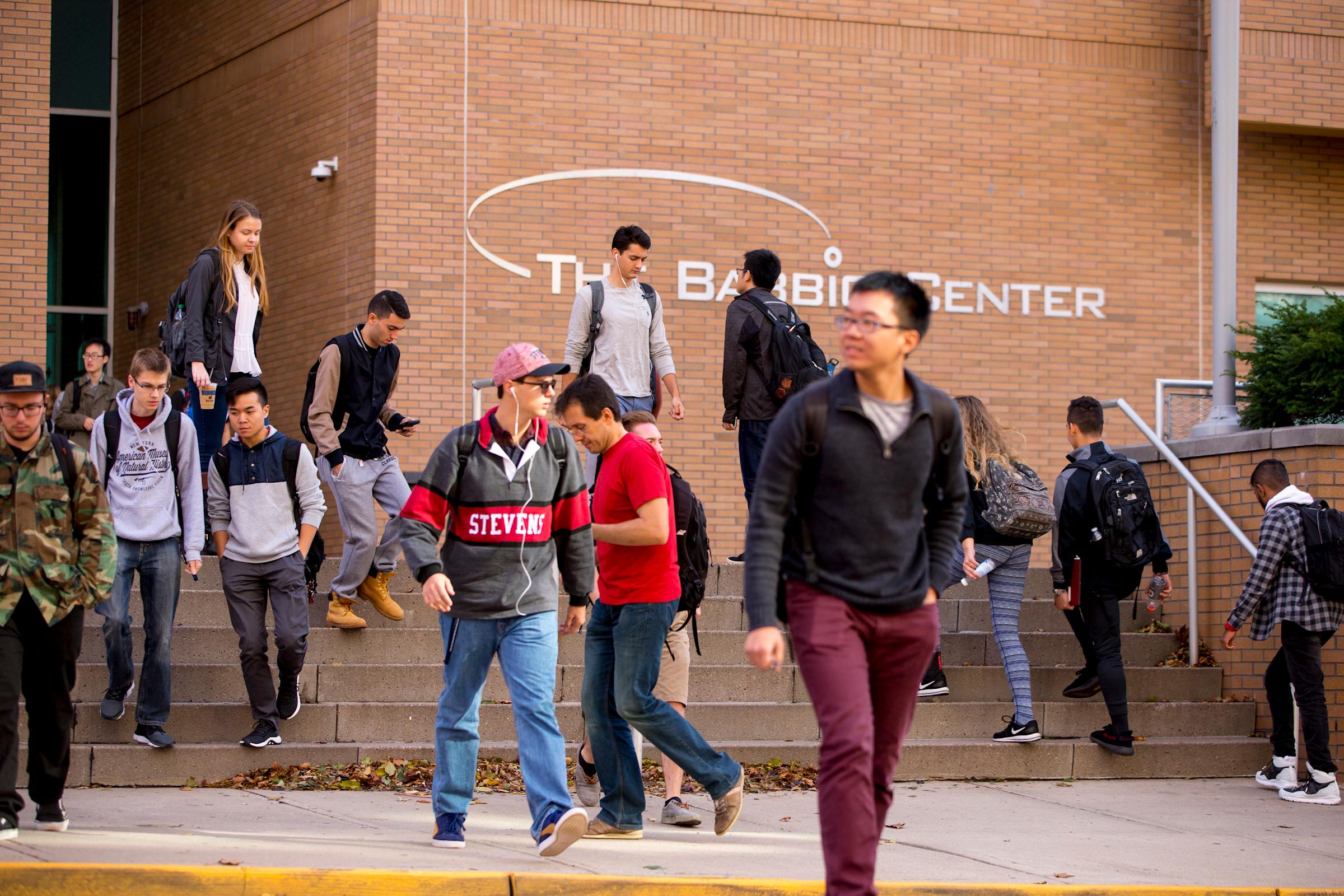 Dozens of students walking outside of Babbio Center on campus at Stevens.