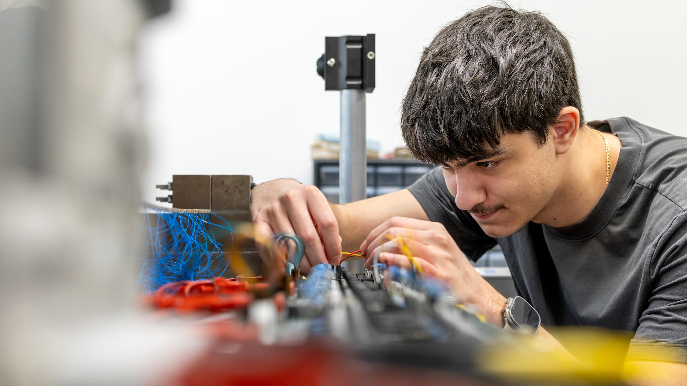 Student working with electronic components in an engineering lab
