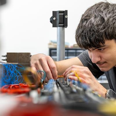 Student working with electronic components in an engineering lab