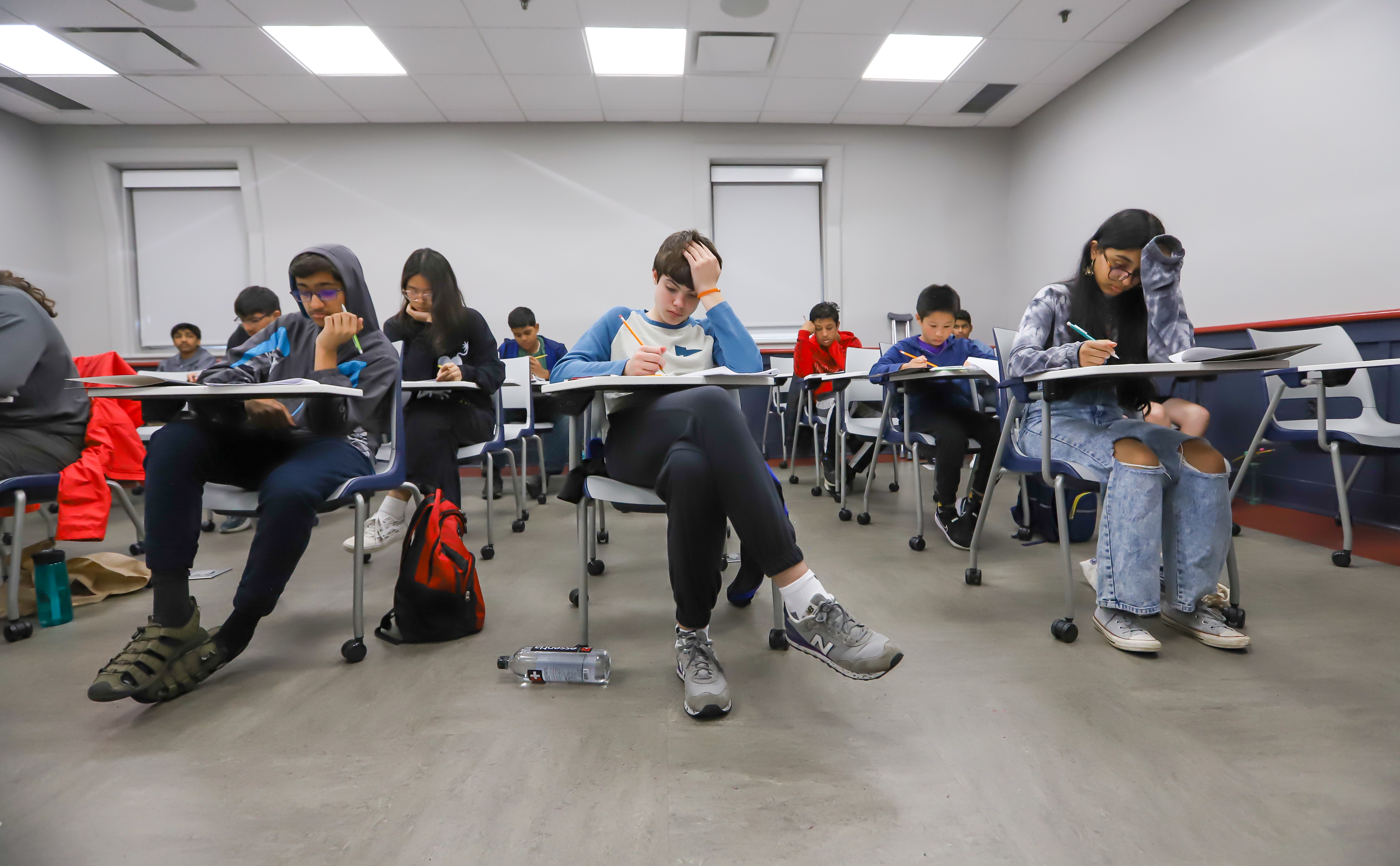 students testing while sitting at desks