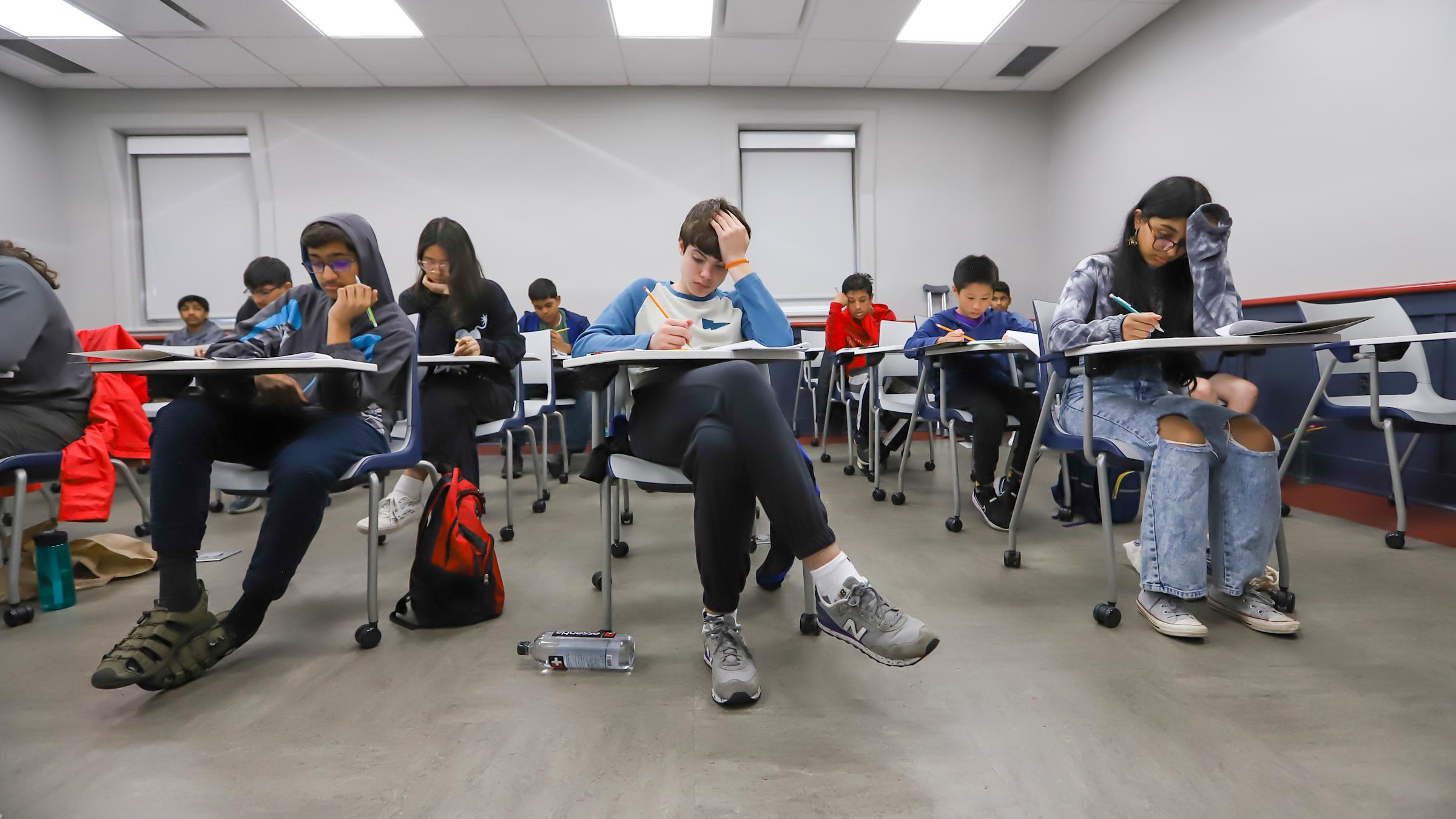 students testing while sitting at desks