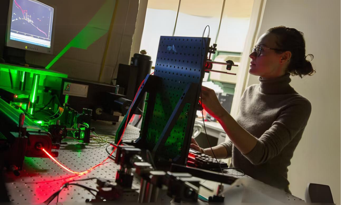 A female student working in a photonics laboratory  