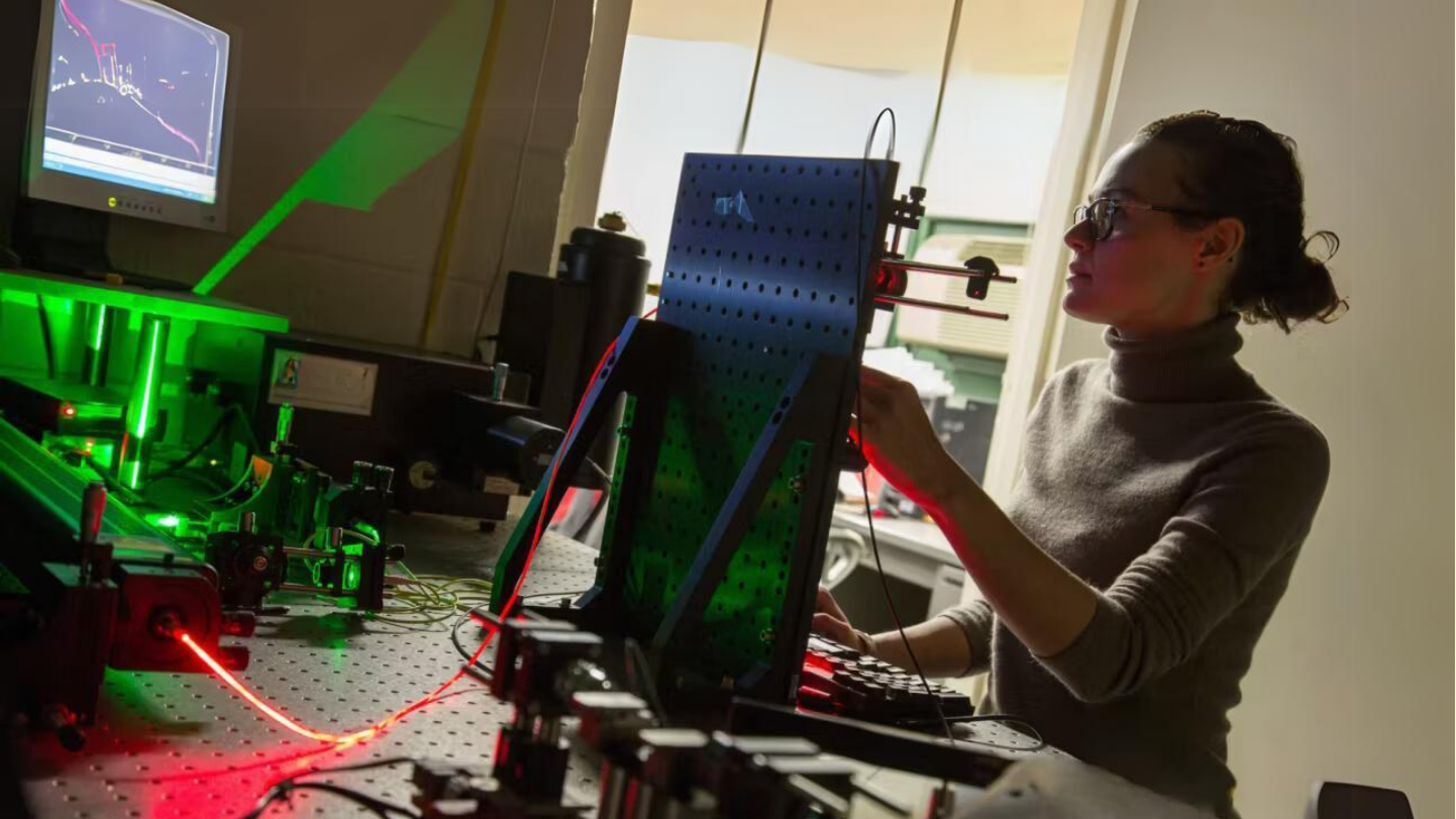 A female student working in a photonics laboratory