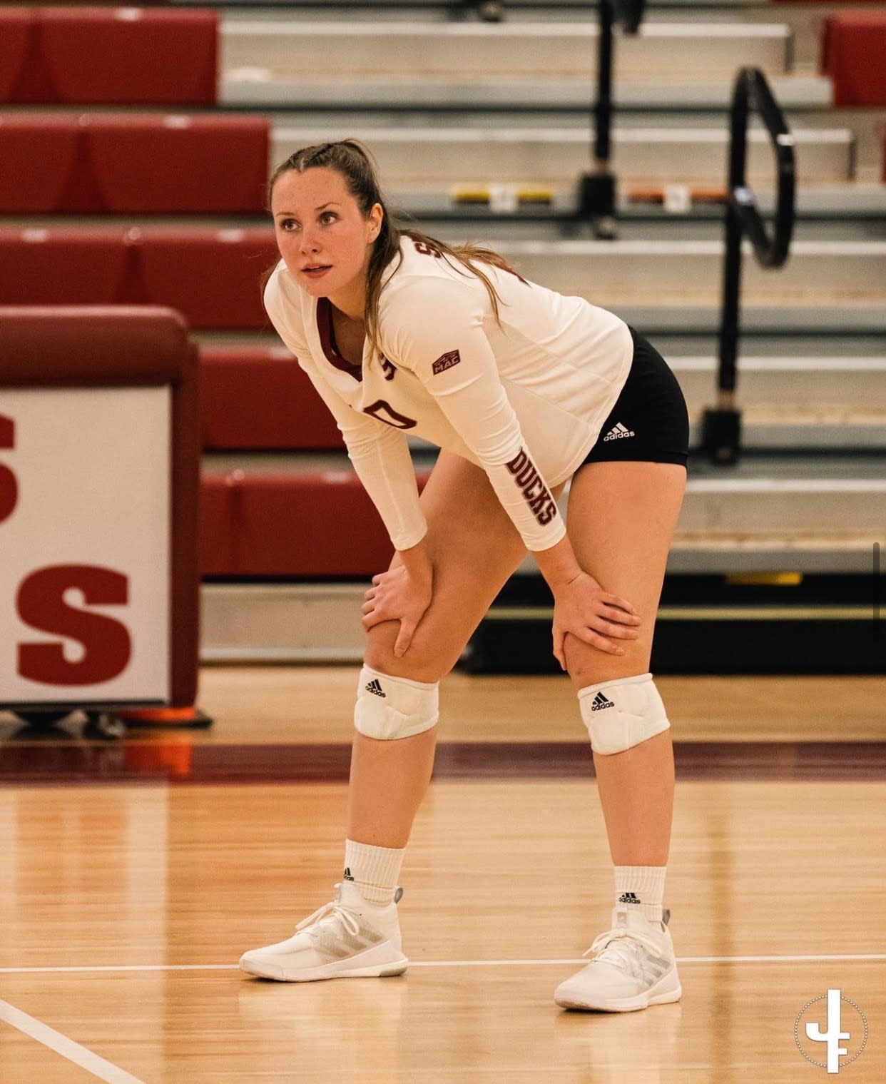 Megan Dion crouched in the gym, ready to play