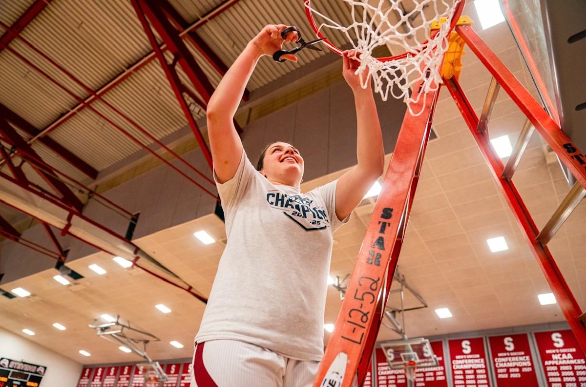 Dorothy Loffredo cuts down the net after a basketball championship