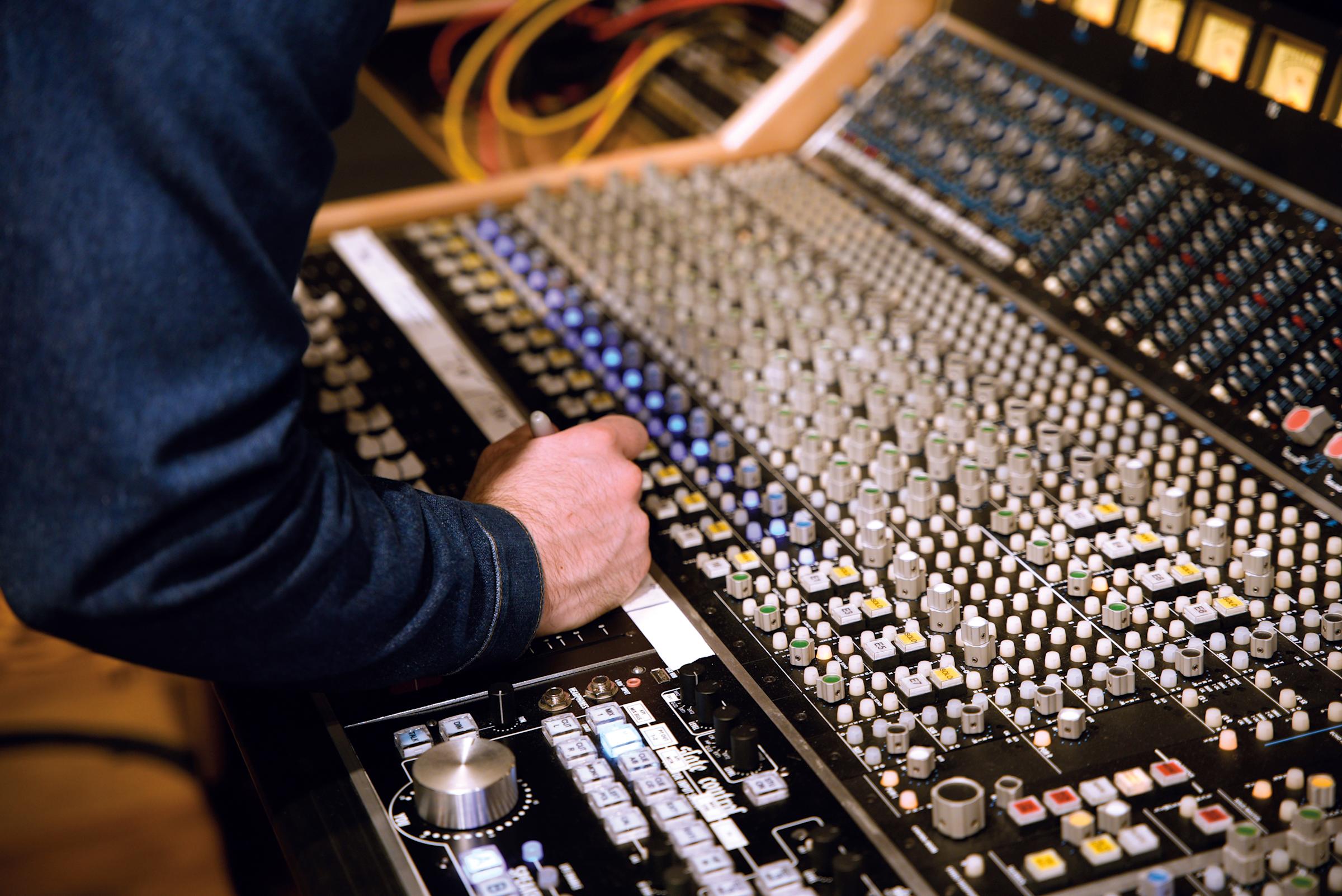 Engineer David Turk at the API 1608 32-channel console inside the Second Take Sound studio