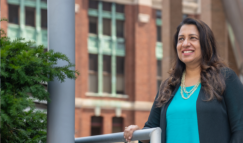 Ratika Gore looks outwards while standing on the balcony of the Babbio Center Plaza 