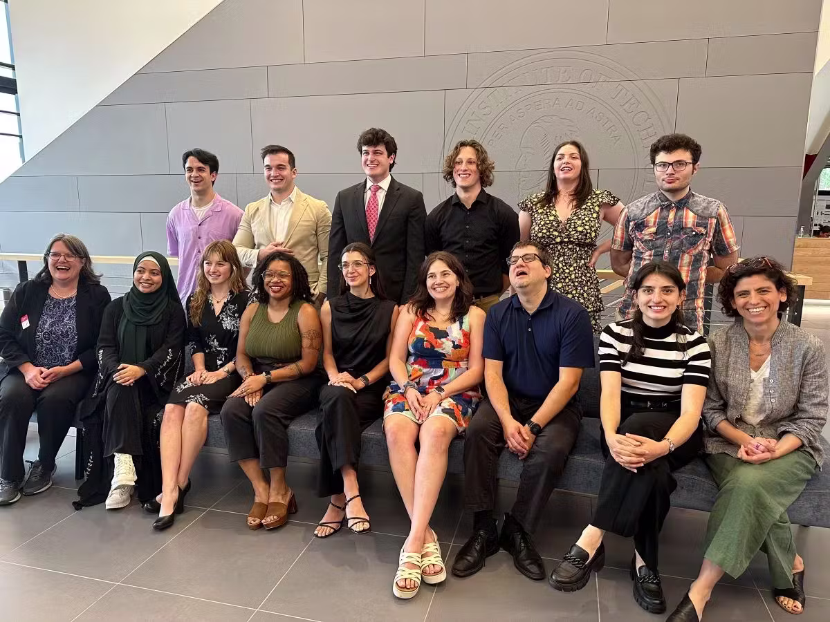 Picture of two rows of REU/RET participants sitting/standing together