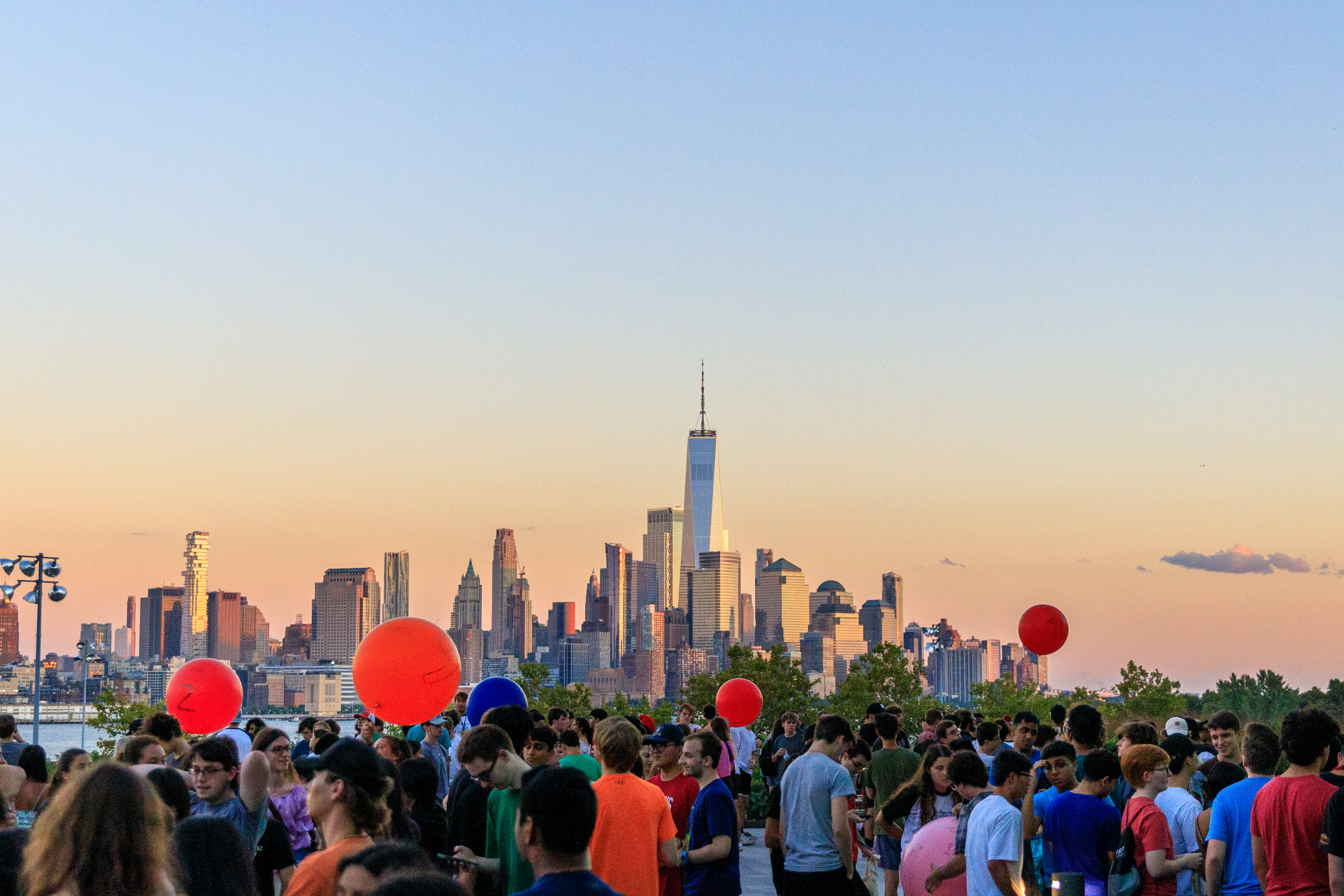 Students release balloons at sunset on Babbio Patio