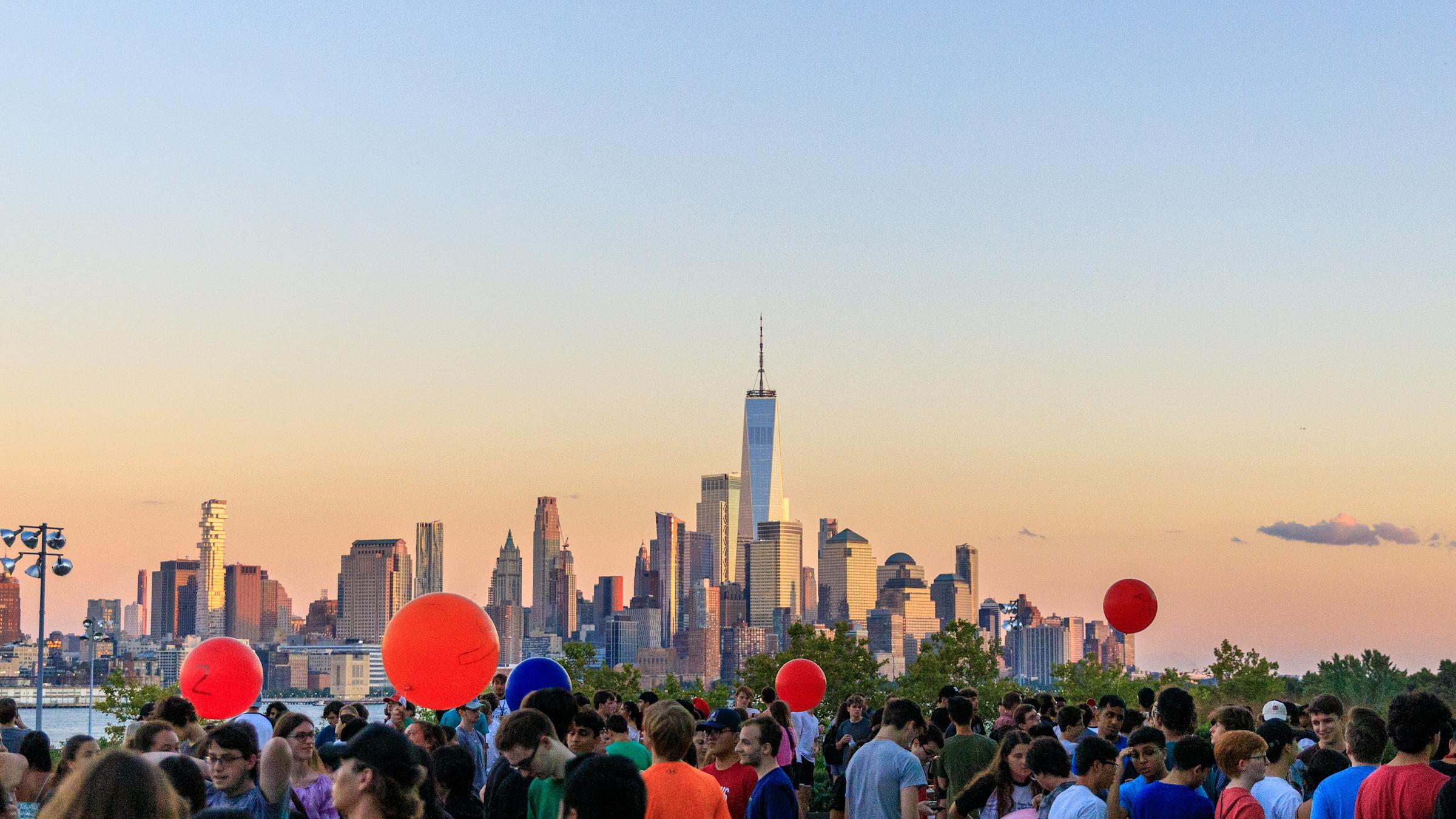 Students release balloons at sunset on Babbio Patio