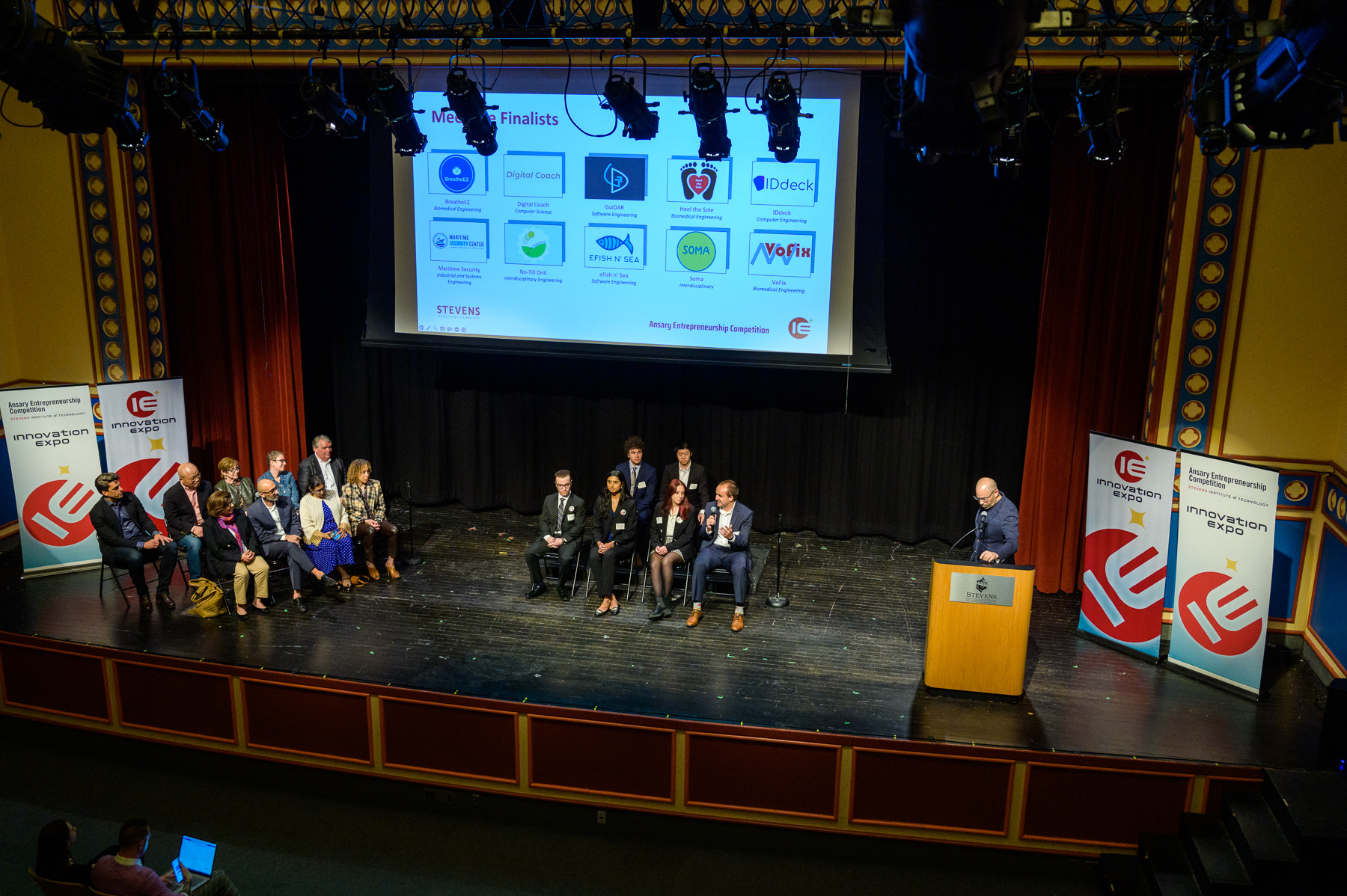 Panelists and student group sitting on stage at Stevens Innovation Expo 2023.