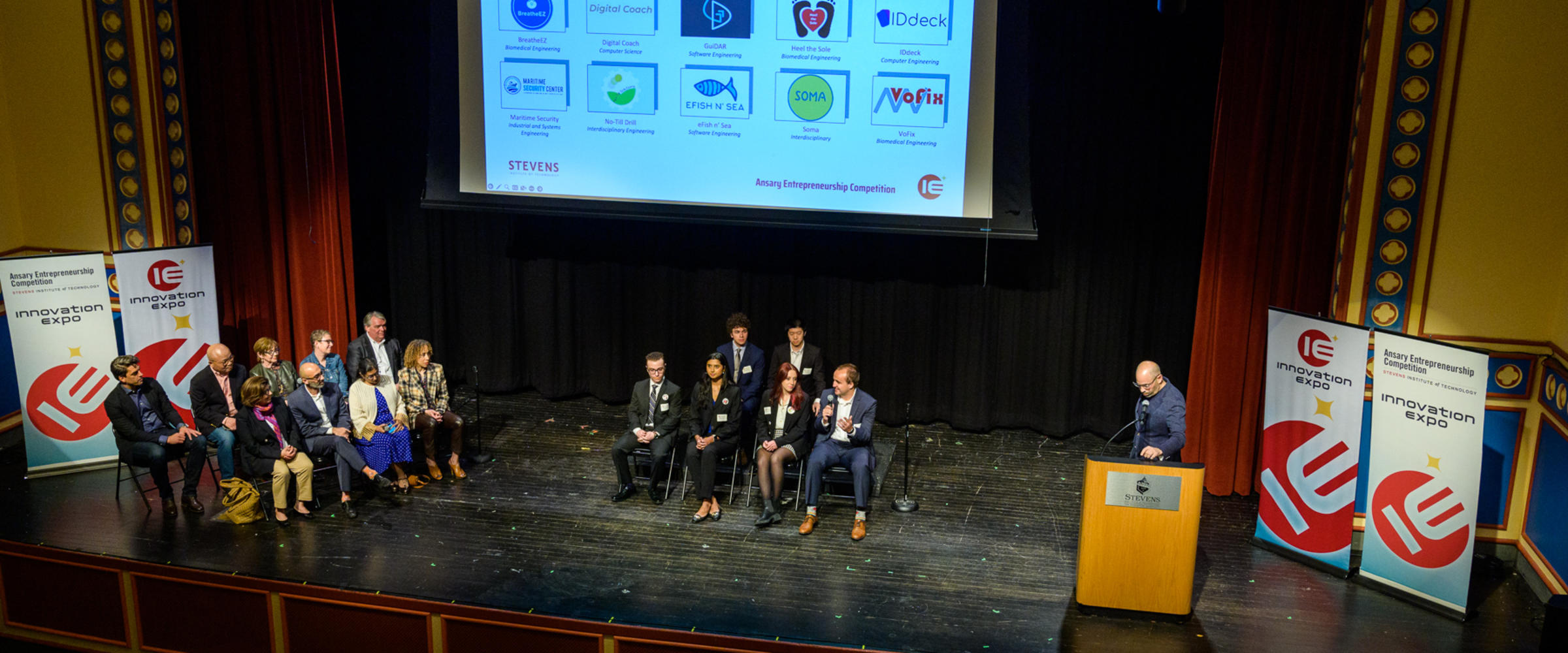 Panelists and student group sitting on stage at Stevens Innovation Expo 2023.