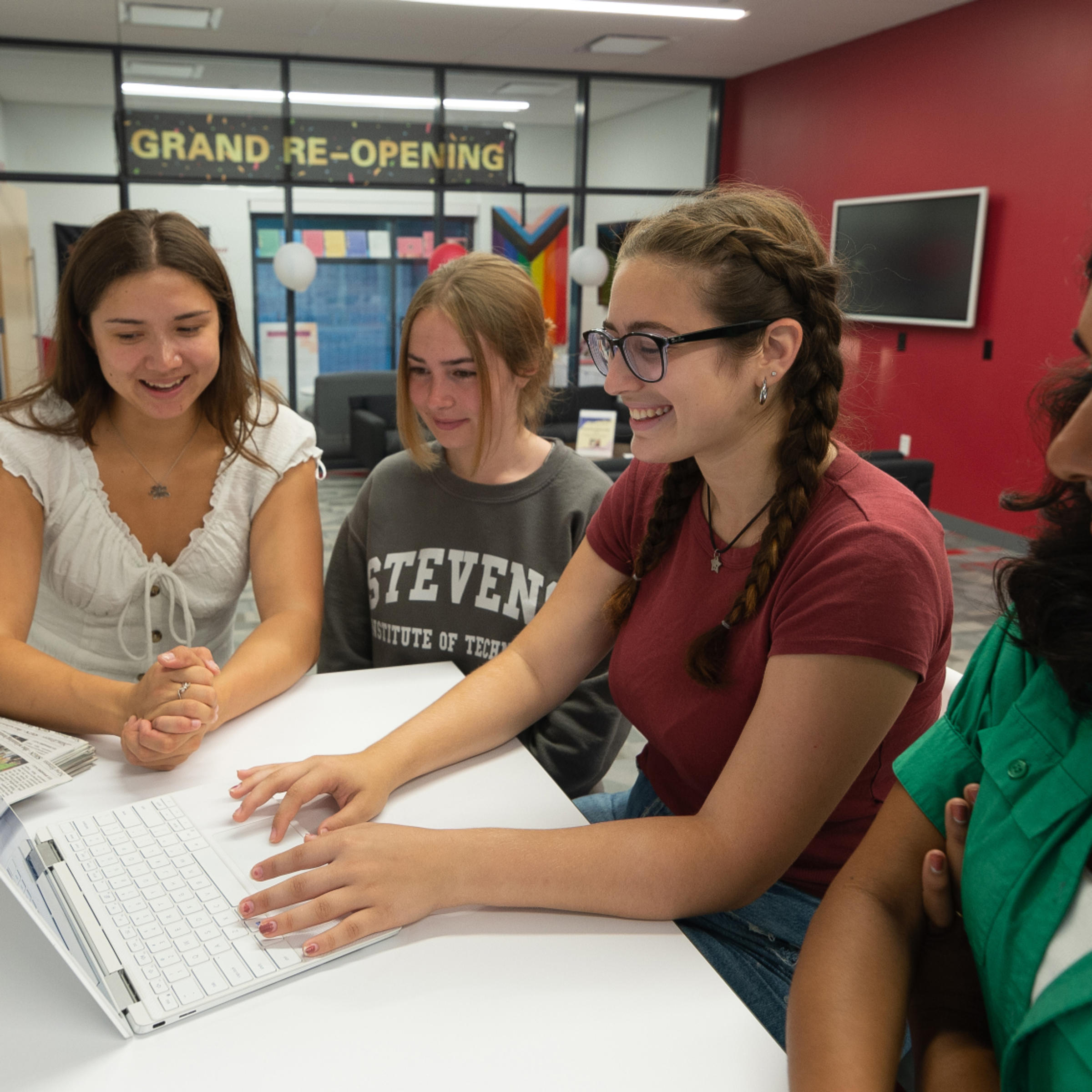 Staff members edit the Stute on their laptop.