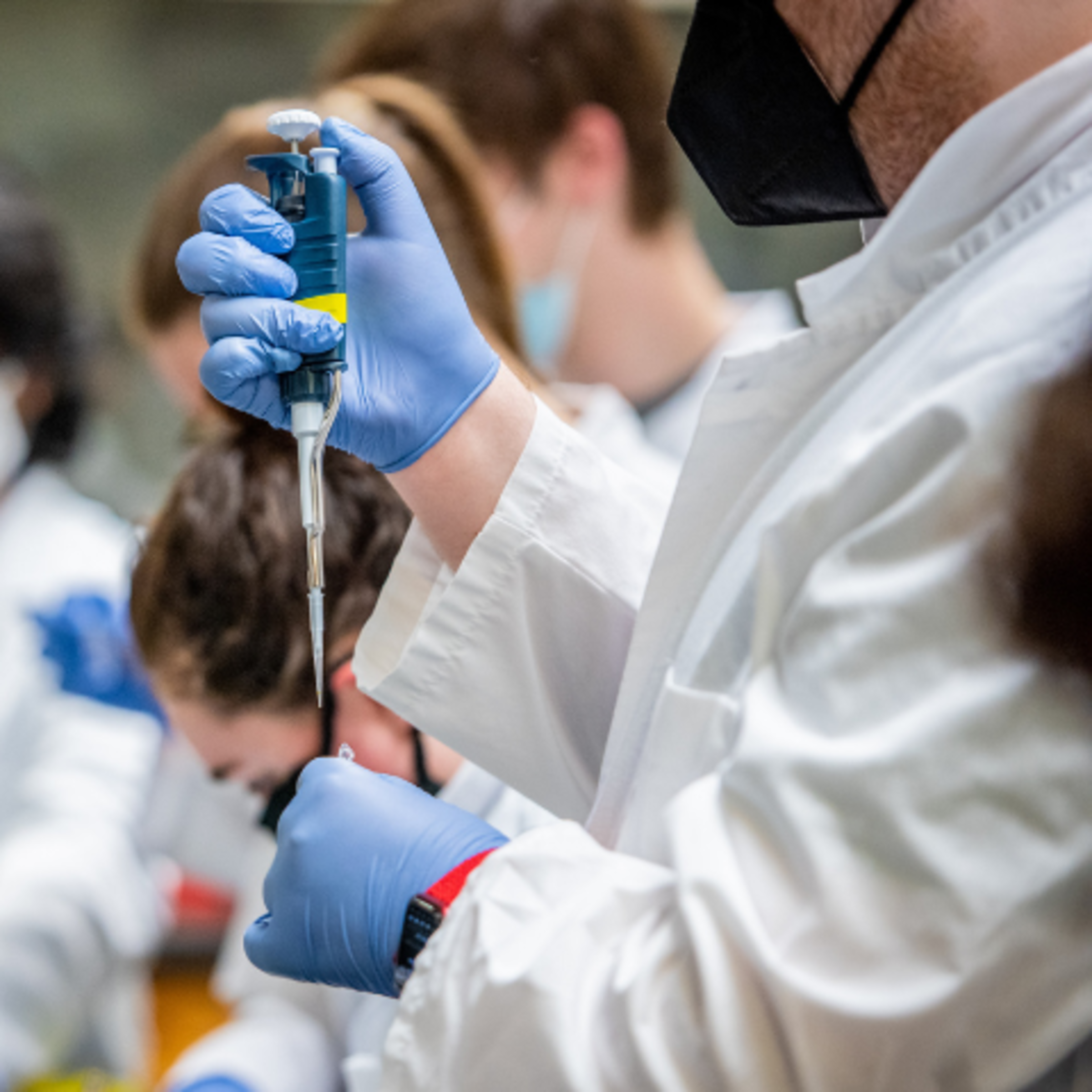 A stock photo of a doctor holding a syringe.