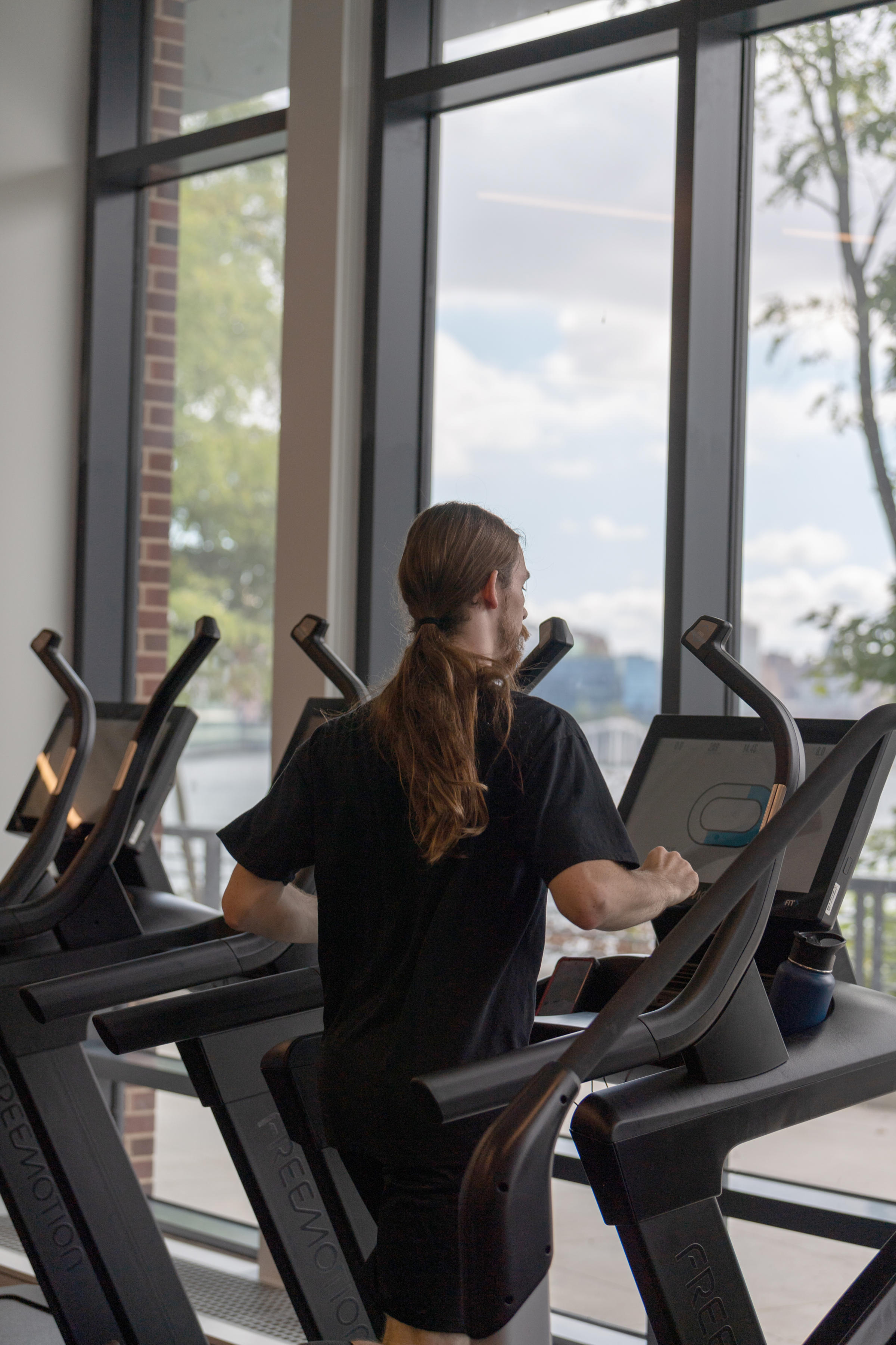 Jogger jogging on treadmill with beautiful view.