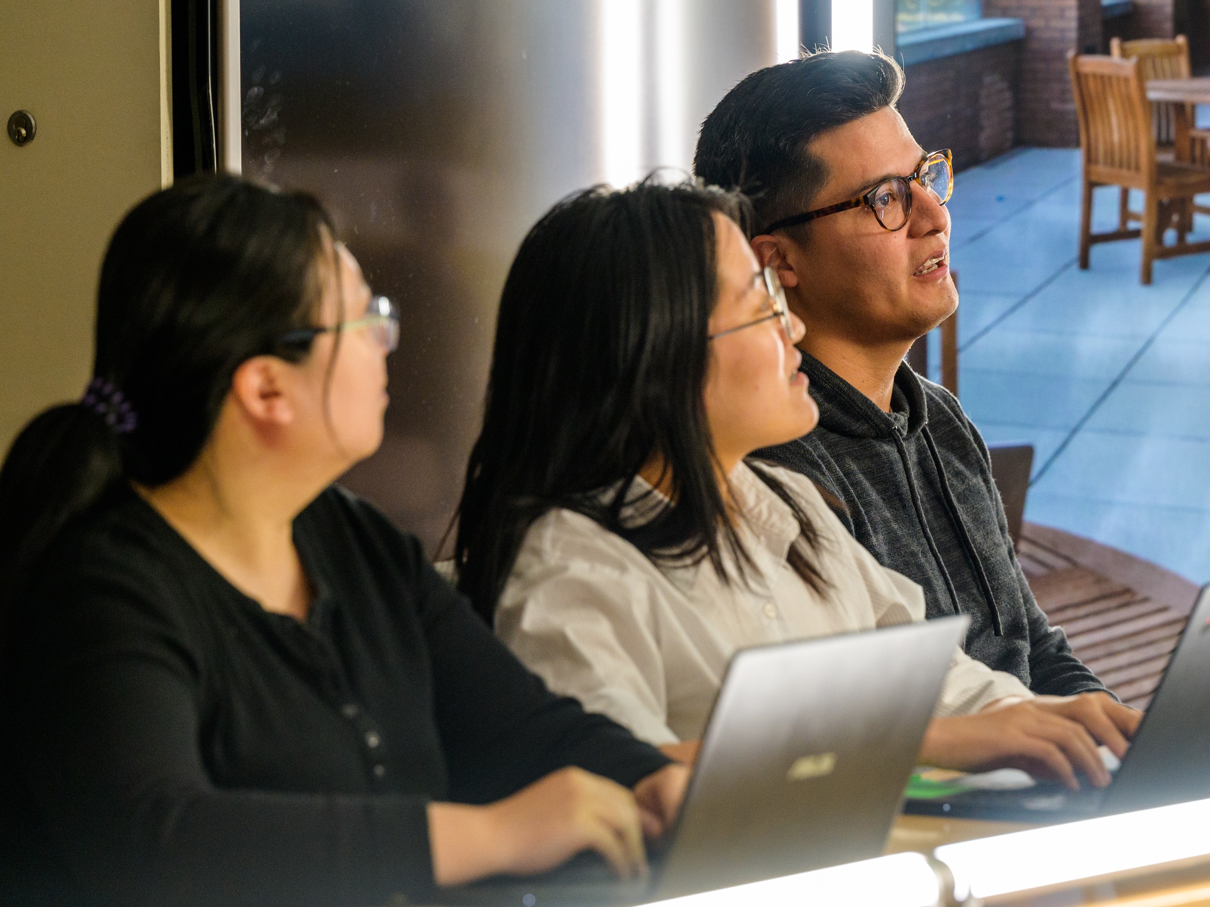 Graduate Students working on Laptops 