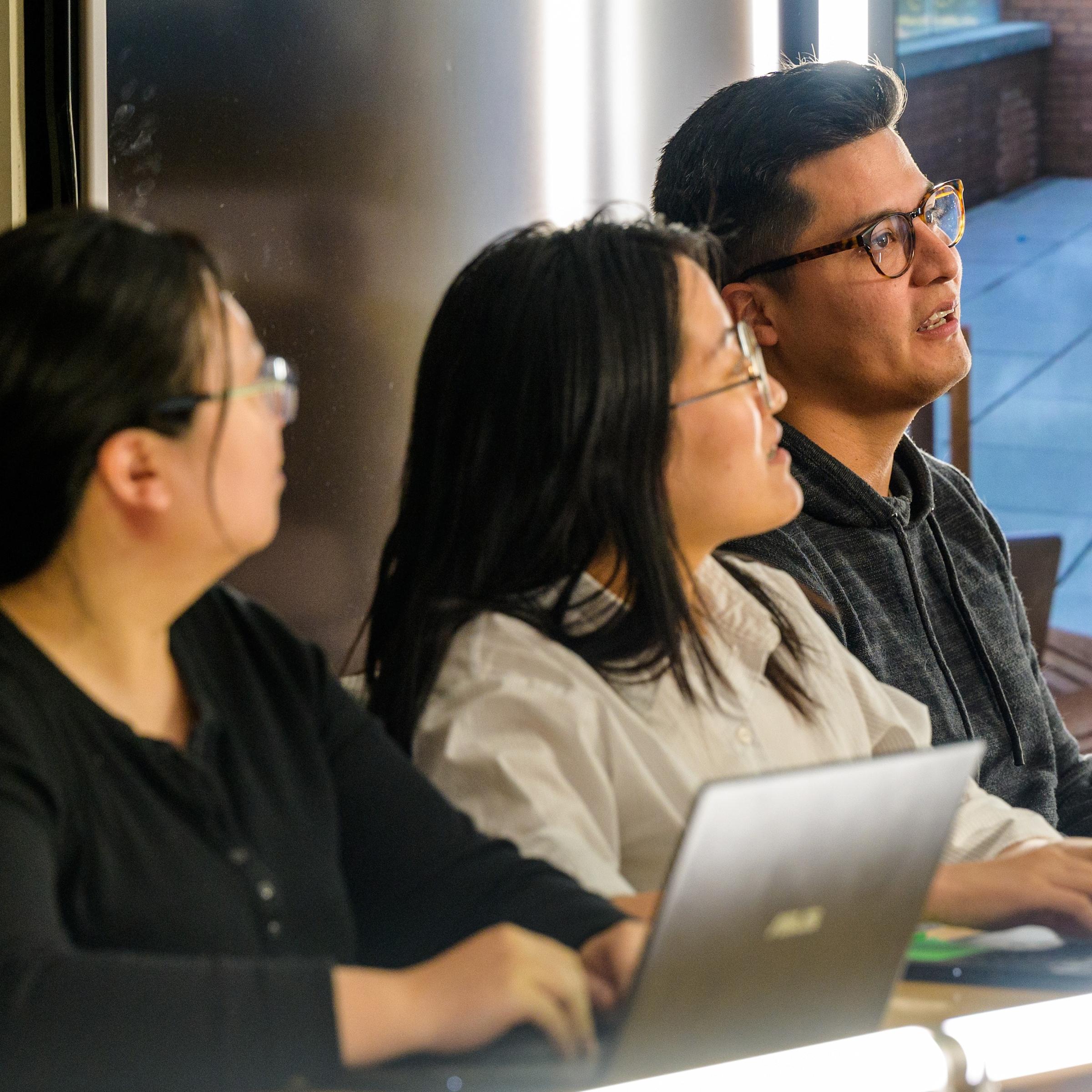 Graduate Students working on Laptops