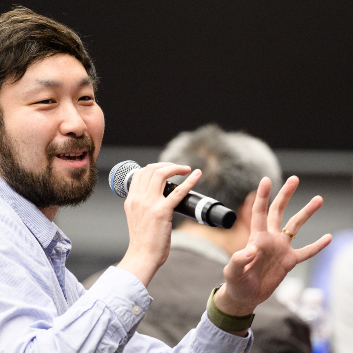 Long Wang with a microphone.