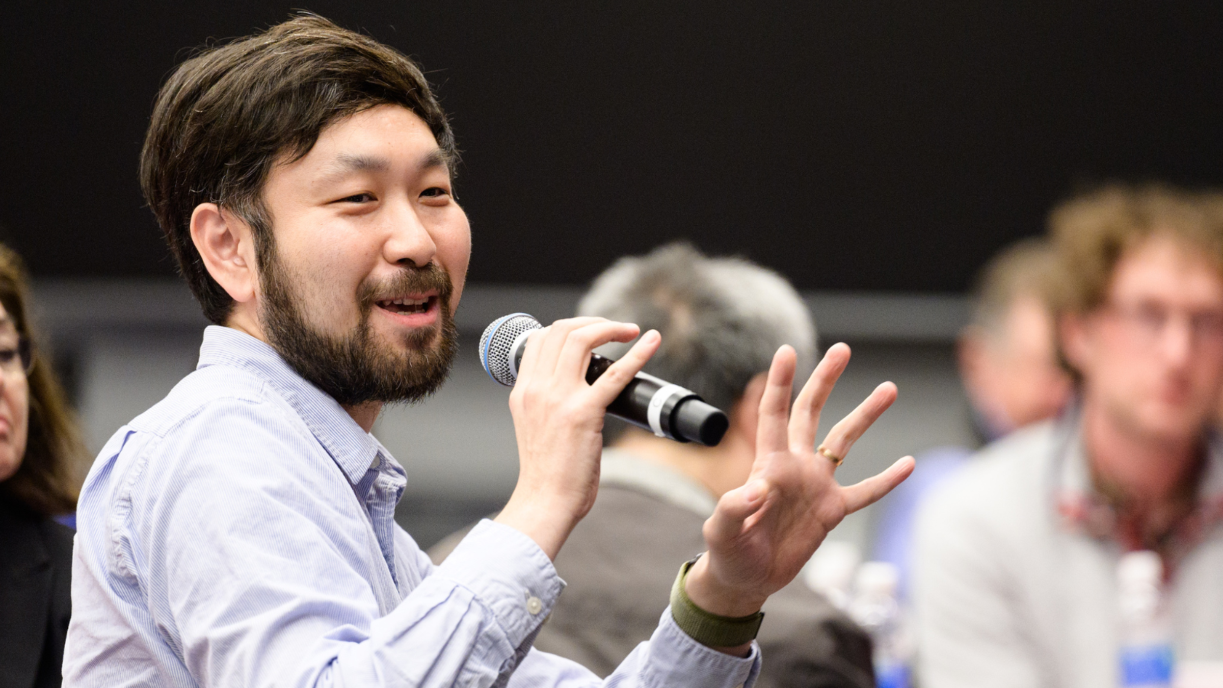 Long Wang with a microphone.