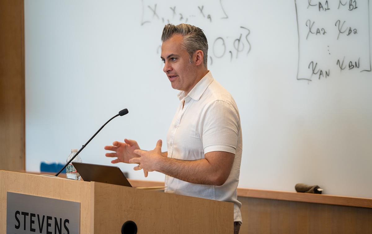 Stevens School of Business professor Dr. Jordan Suchow teaches a group of pre-college students about AI and app creation tools.