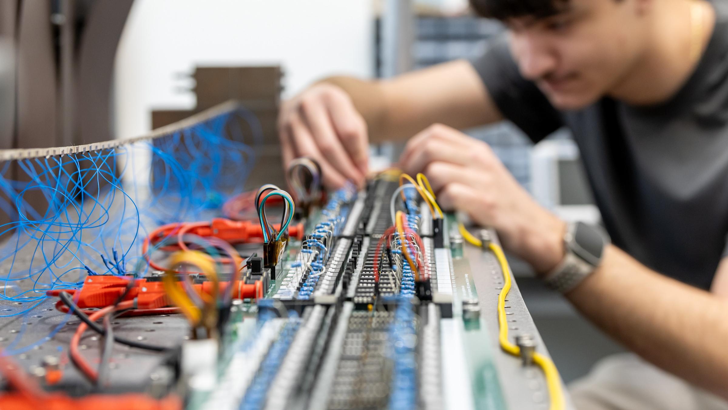 A student working on a circuit board.