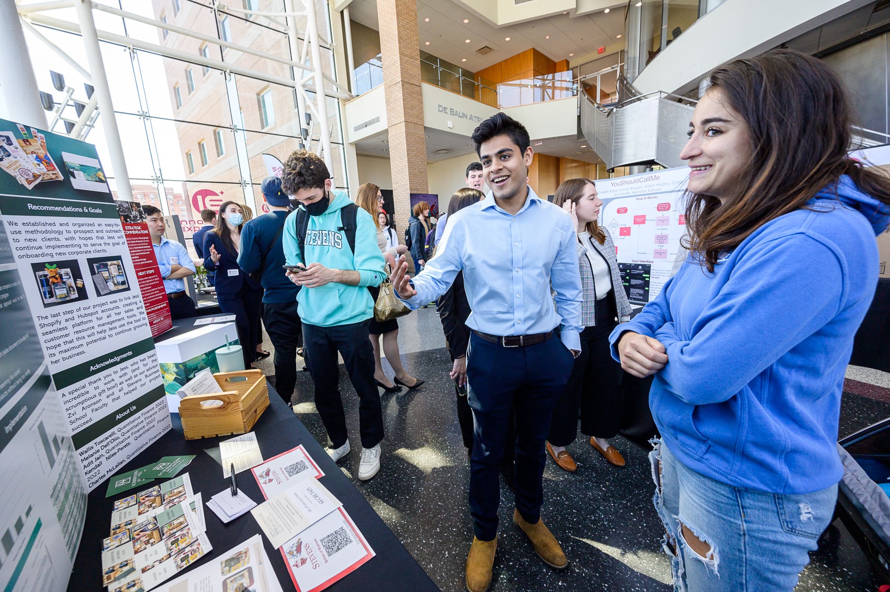 male student smiling and showing project during Stevens Innovation Expo