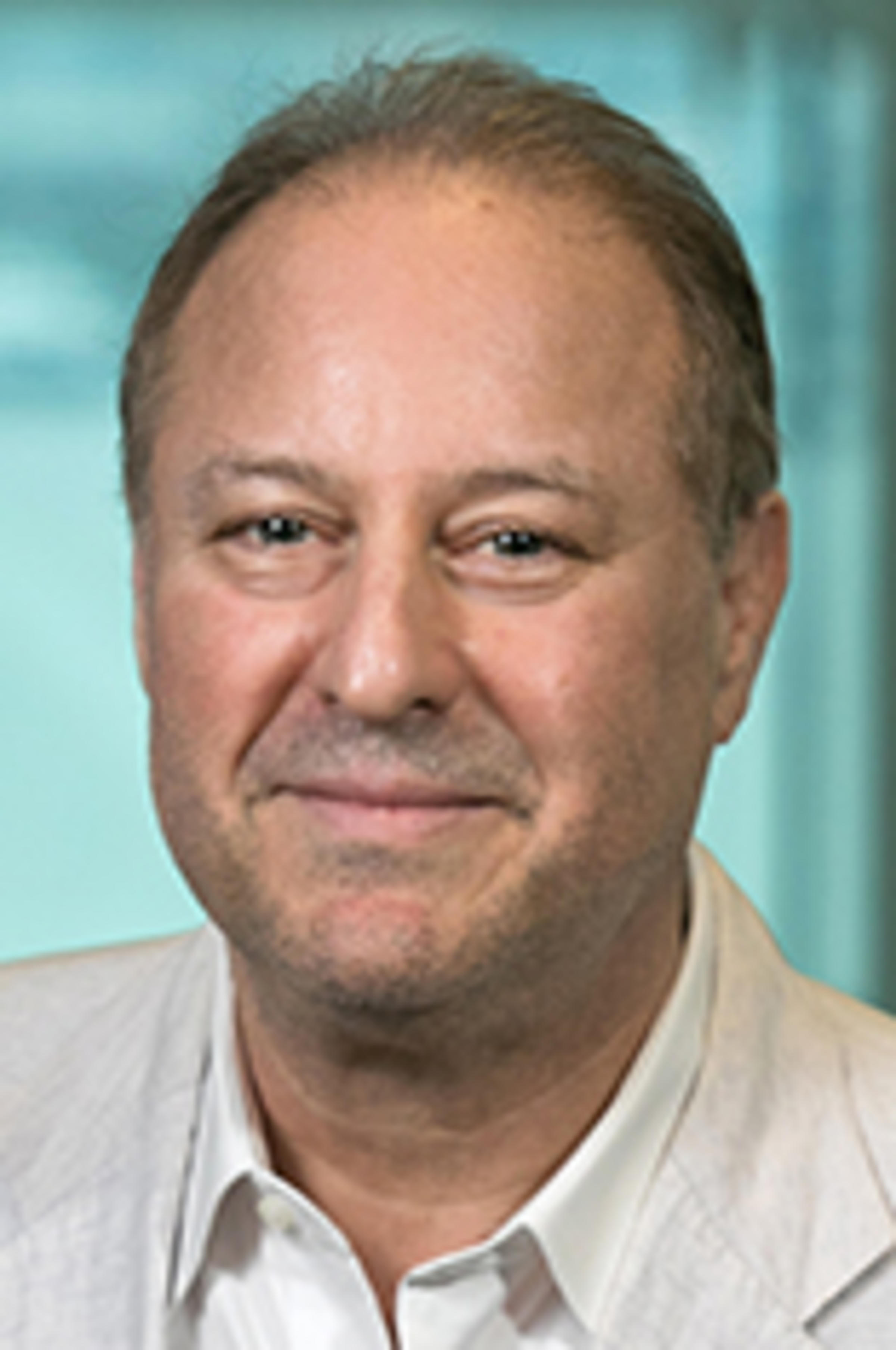 Headshot of Dr. Jon Kaufman with the New York City skyline in the background.