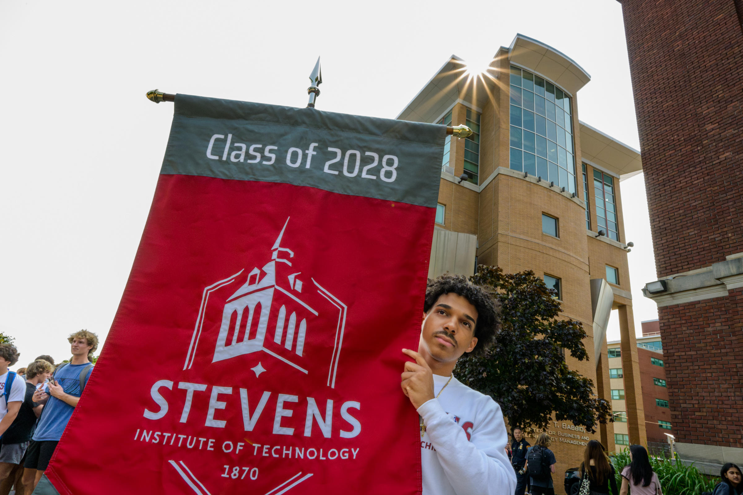 The Class of 2028 banner carrier prepares to lead the Class of 2028 in the first-year Wittpenn Walk.