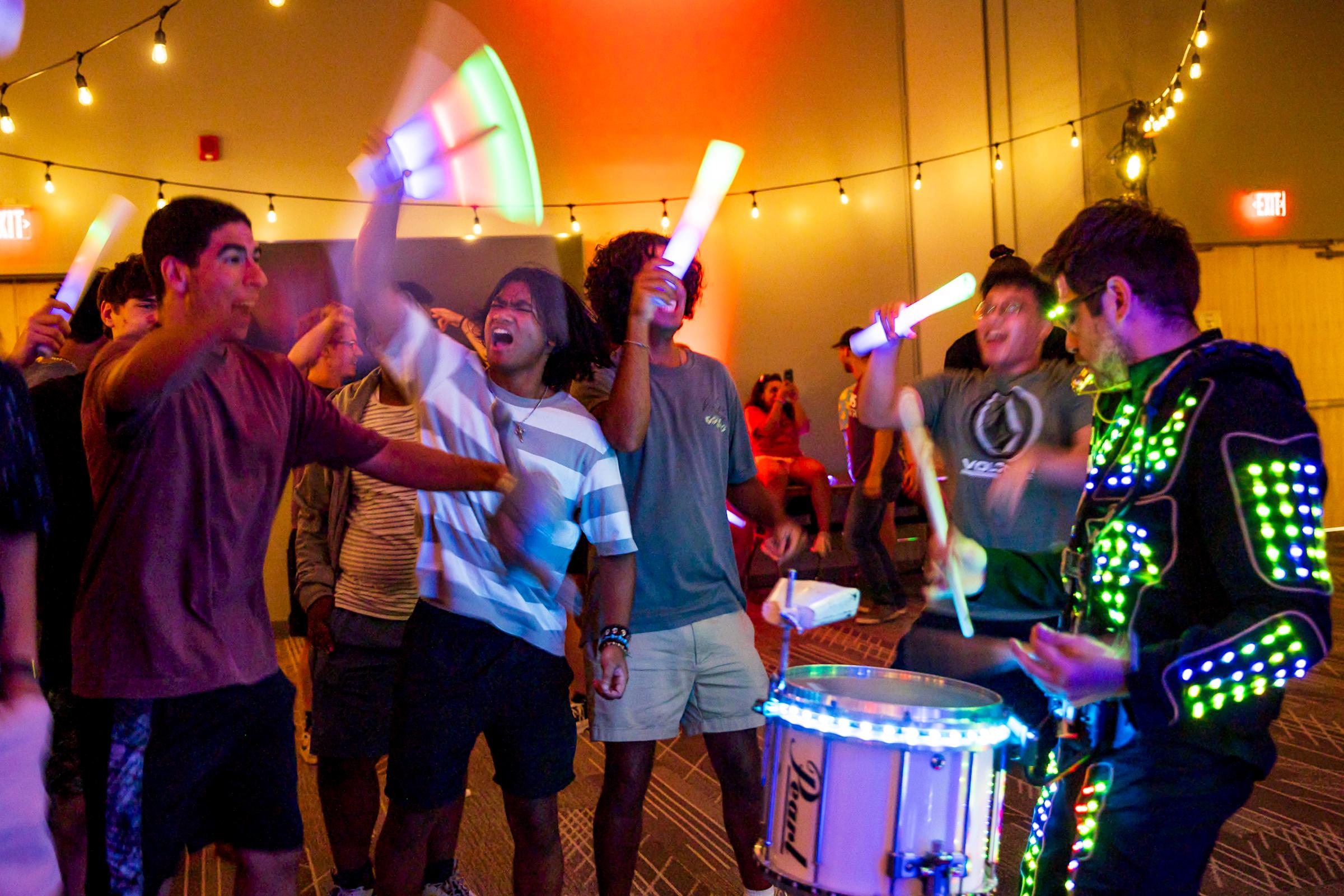 Students jam out with glow sticks.