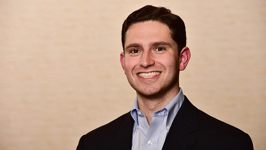Seth Kirschner in a dark jacket and blue shirt in Deloitte's New York offices.