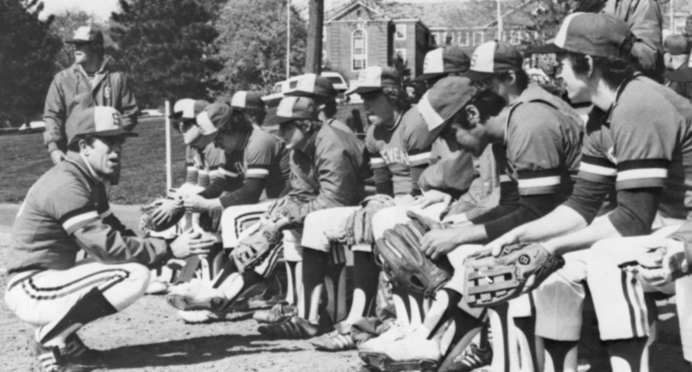 Photo from 1980s of coach Whittaker speaking to baseball team.