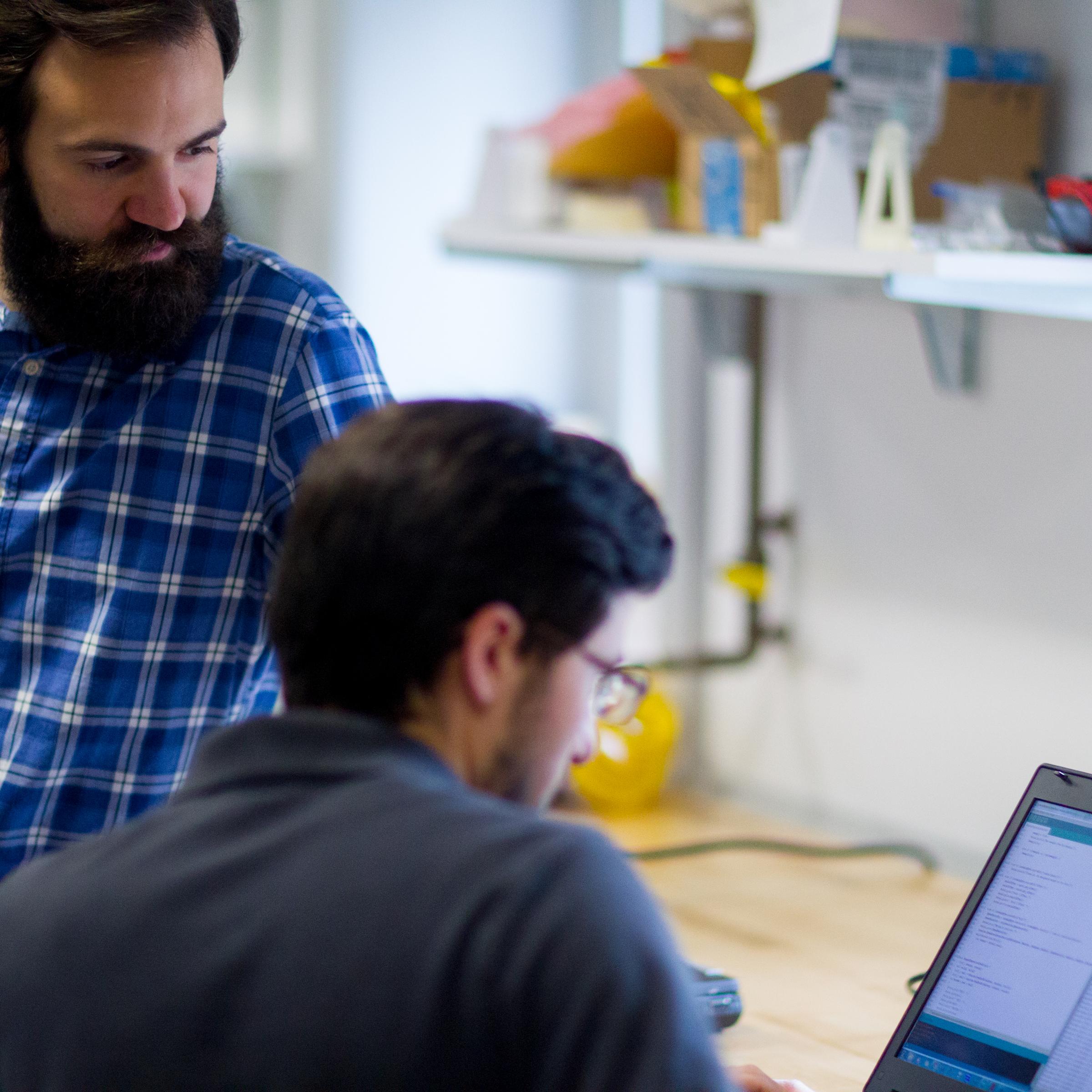 two students viewing a laptop