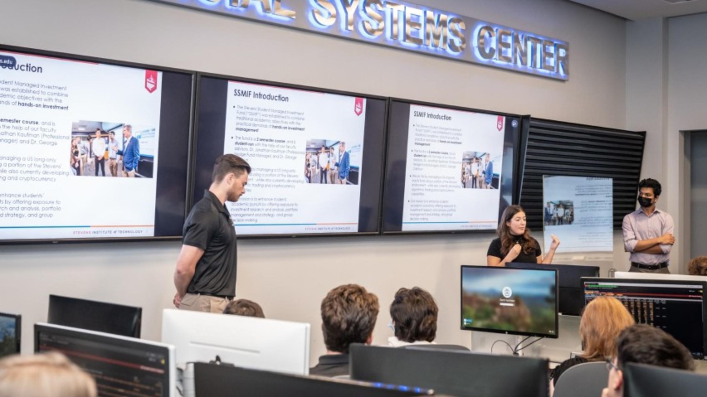 The SMIF's senior management team (from left), Justin Doyle '23, Doris Vazacopolous '23 and Matthew Thomas '24 present to visiting MDC students.