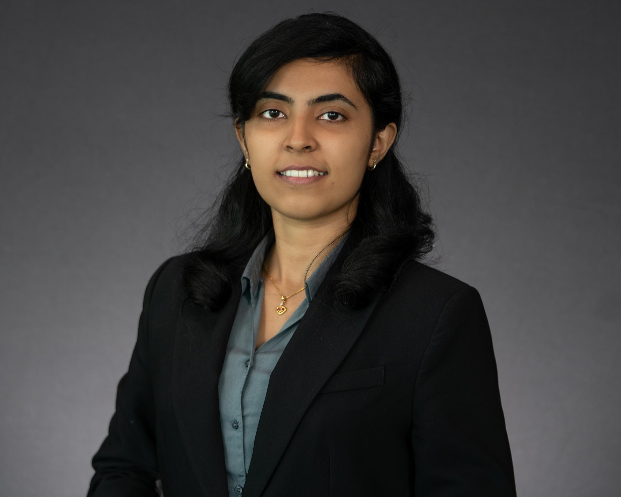 Headshot of Alwin John dressed in professional attire