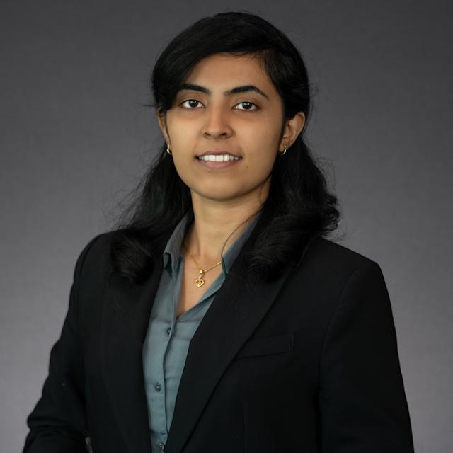 Headshot of Alwin John dressed in professional attire
