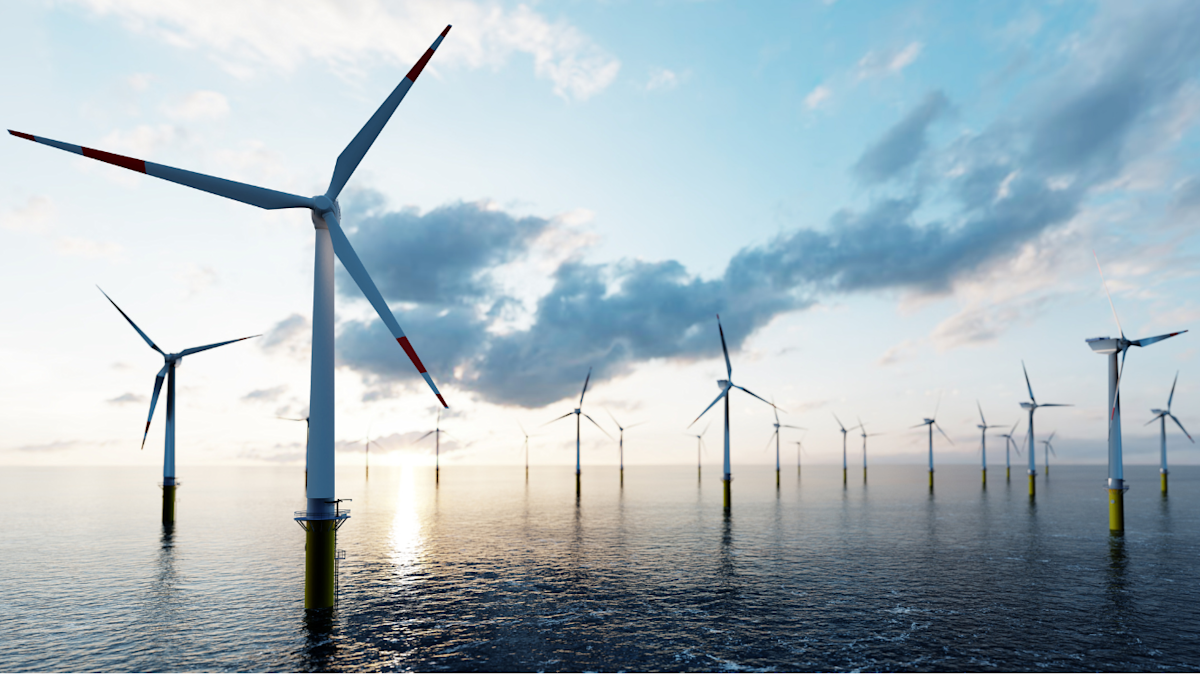 A series of windmills in the ocean as part of an offshore wind farm.