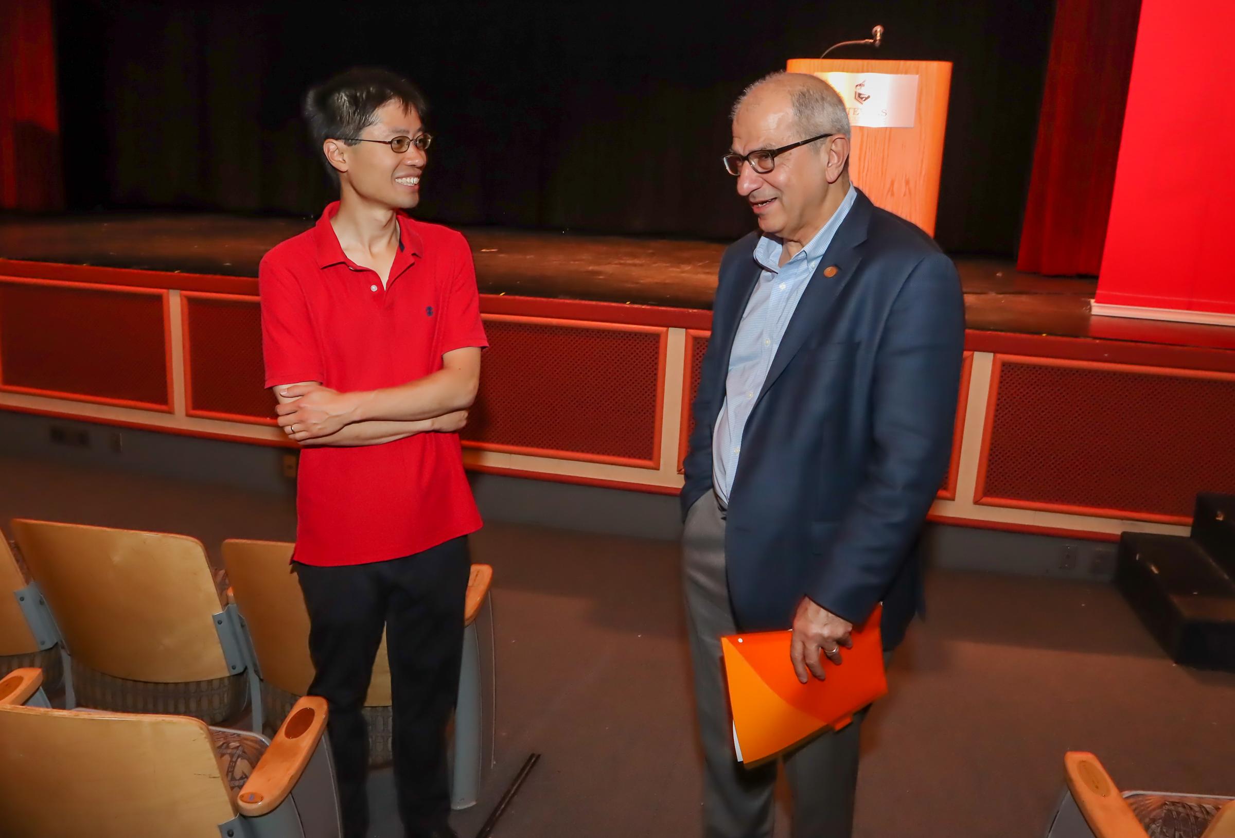 Po-Shen Loh and Nariman Favardin standing, in conversation