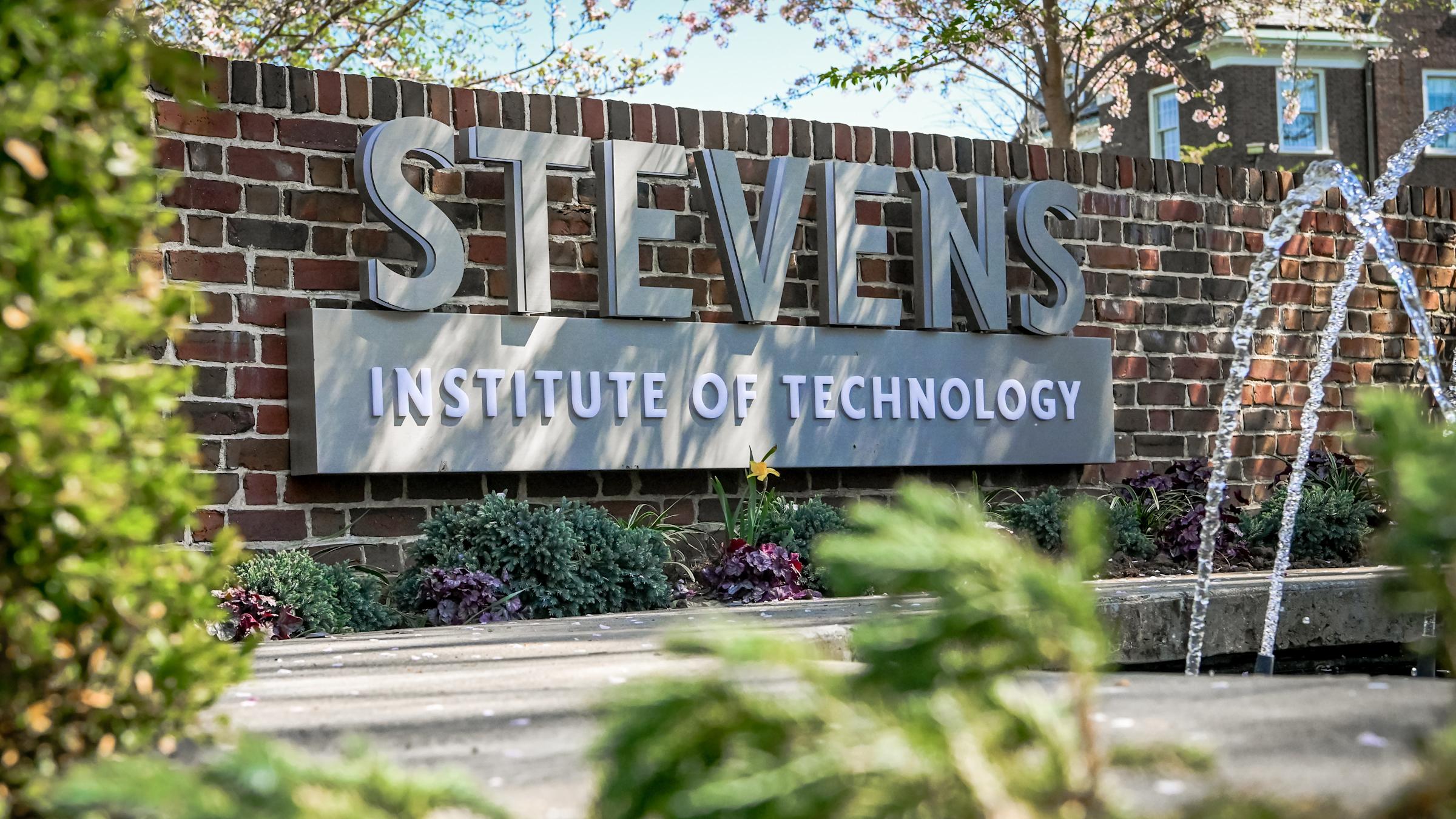 Stevens wordmark on brick wall behind Hoxie House fountain