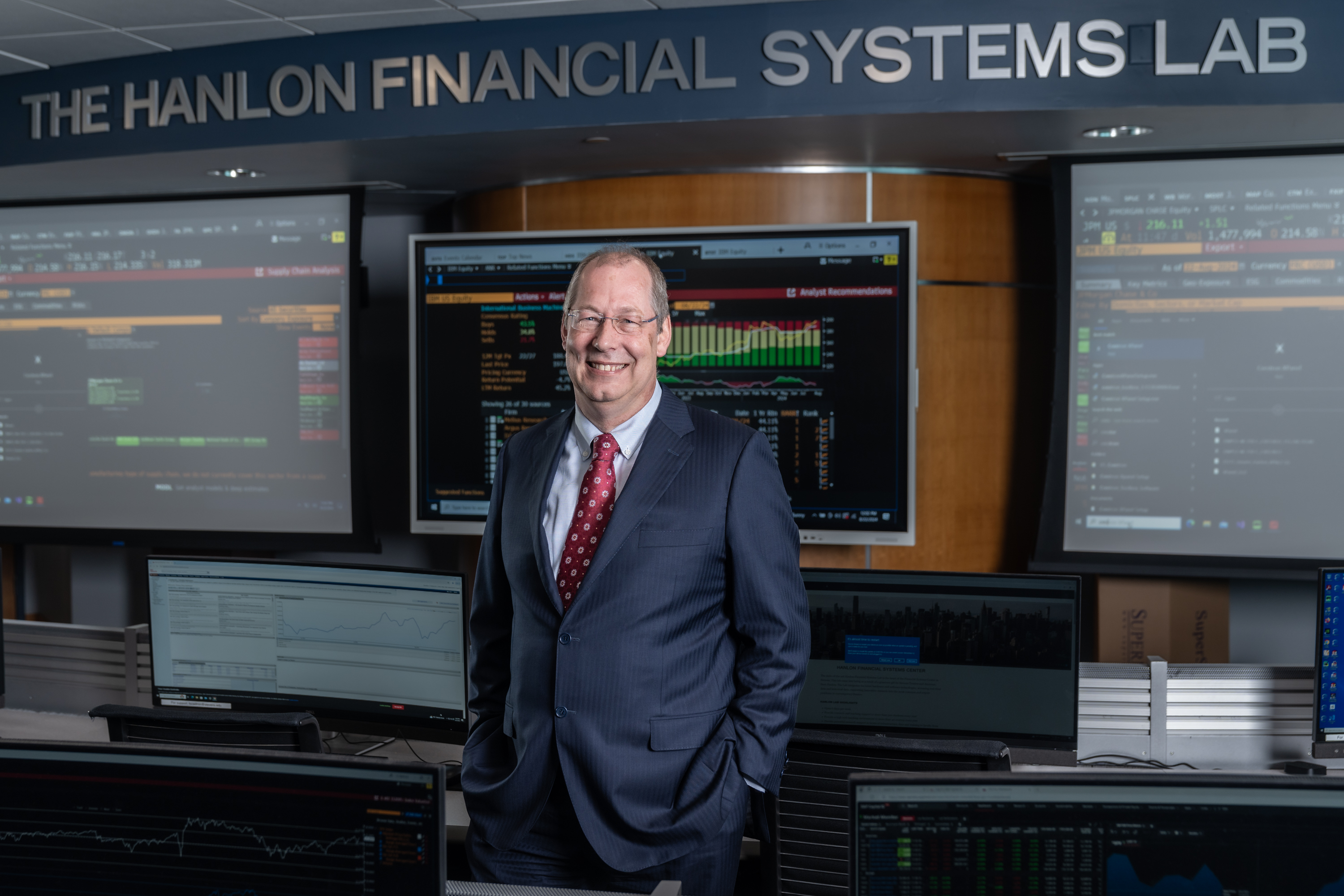 GJ de Vreede stands in front of the display screens in the Hanlon Financial Systems Center.