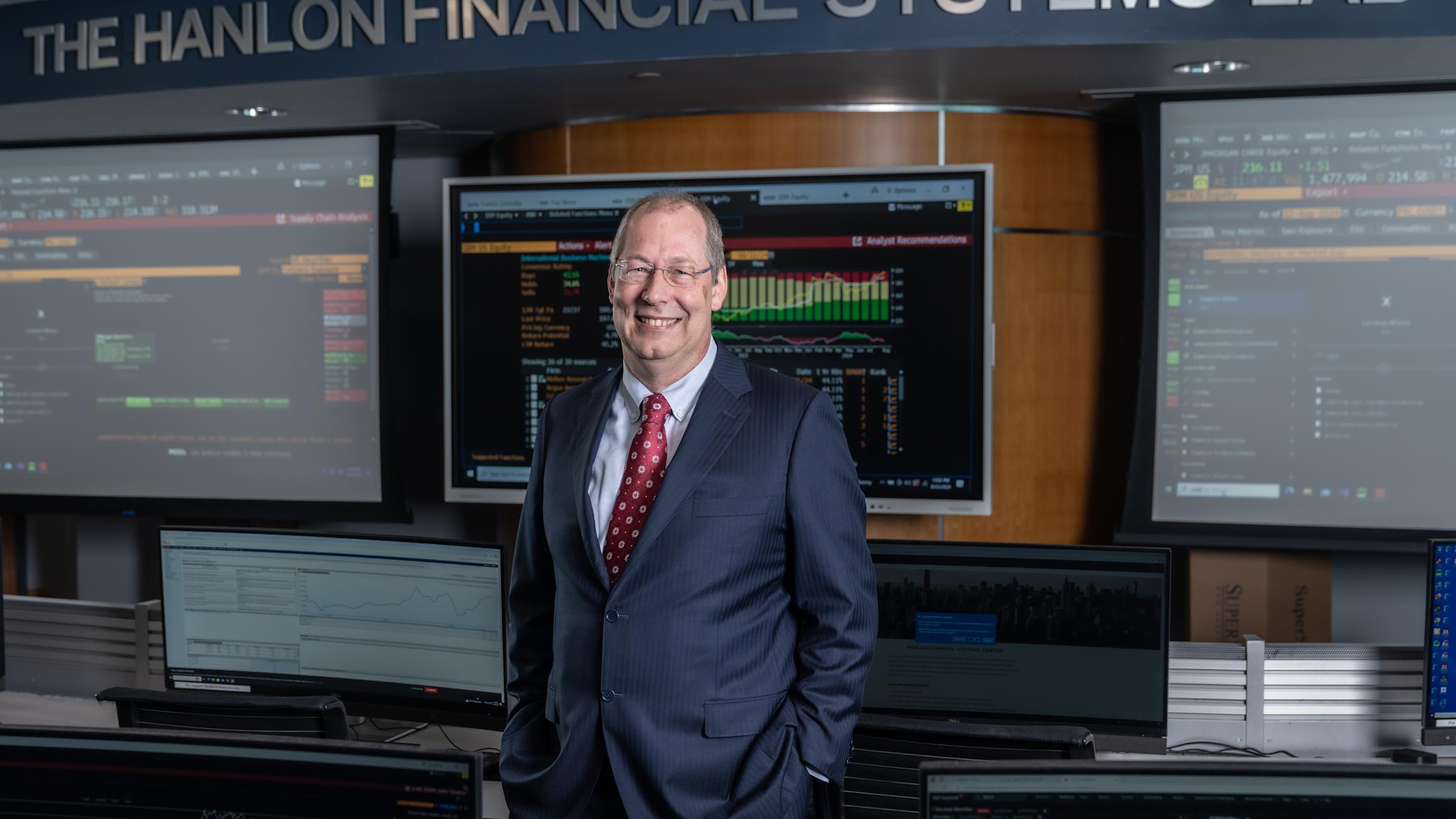 GJ de Vreede stands in front of the display screens in the Hanlon Financial Systems Center.